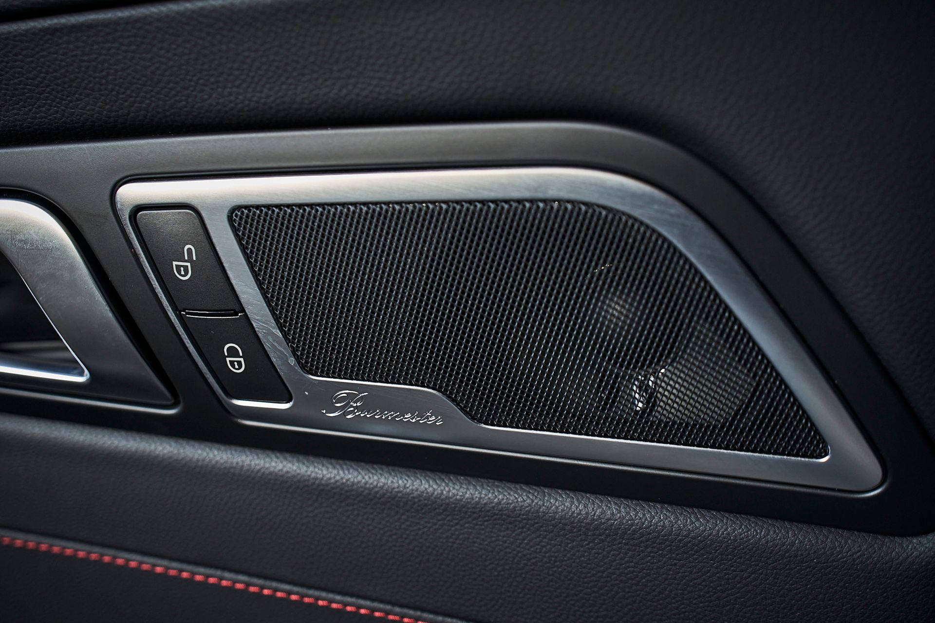 A close up of a car door with a speaker on it