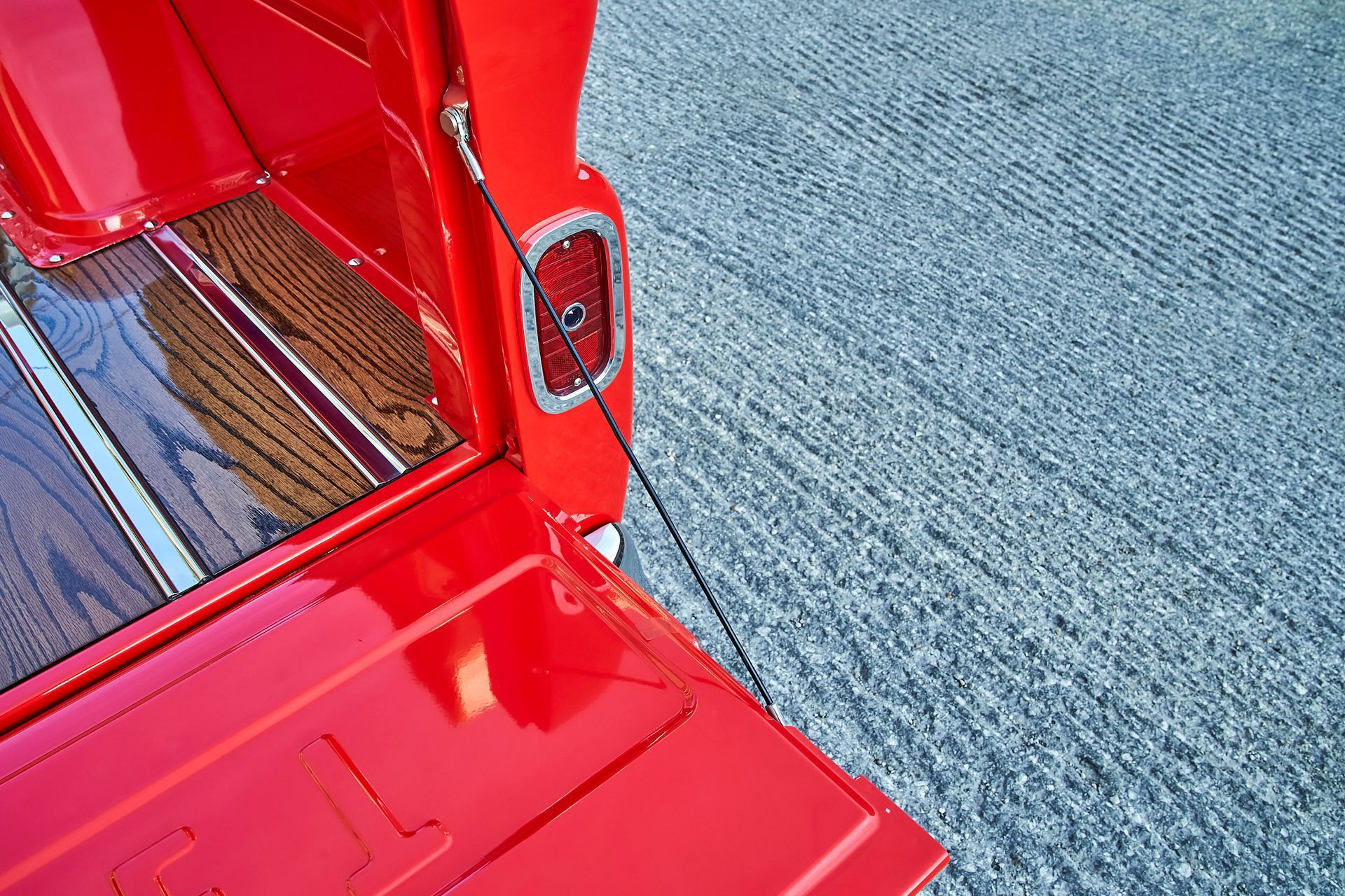 The back of a red truck is open and sitting on a carpet.