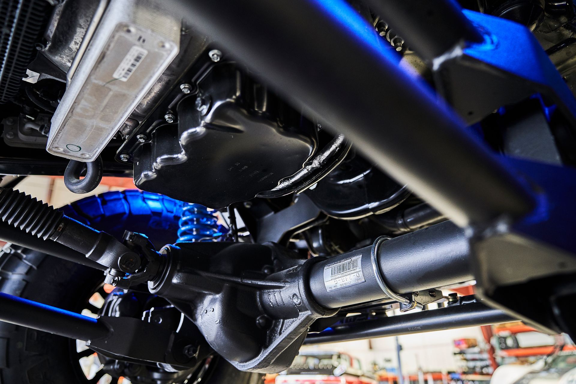 A close up of the underside of a car with blue lights on it.