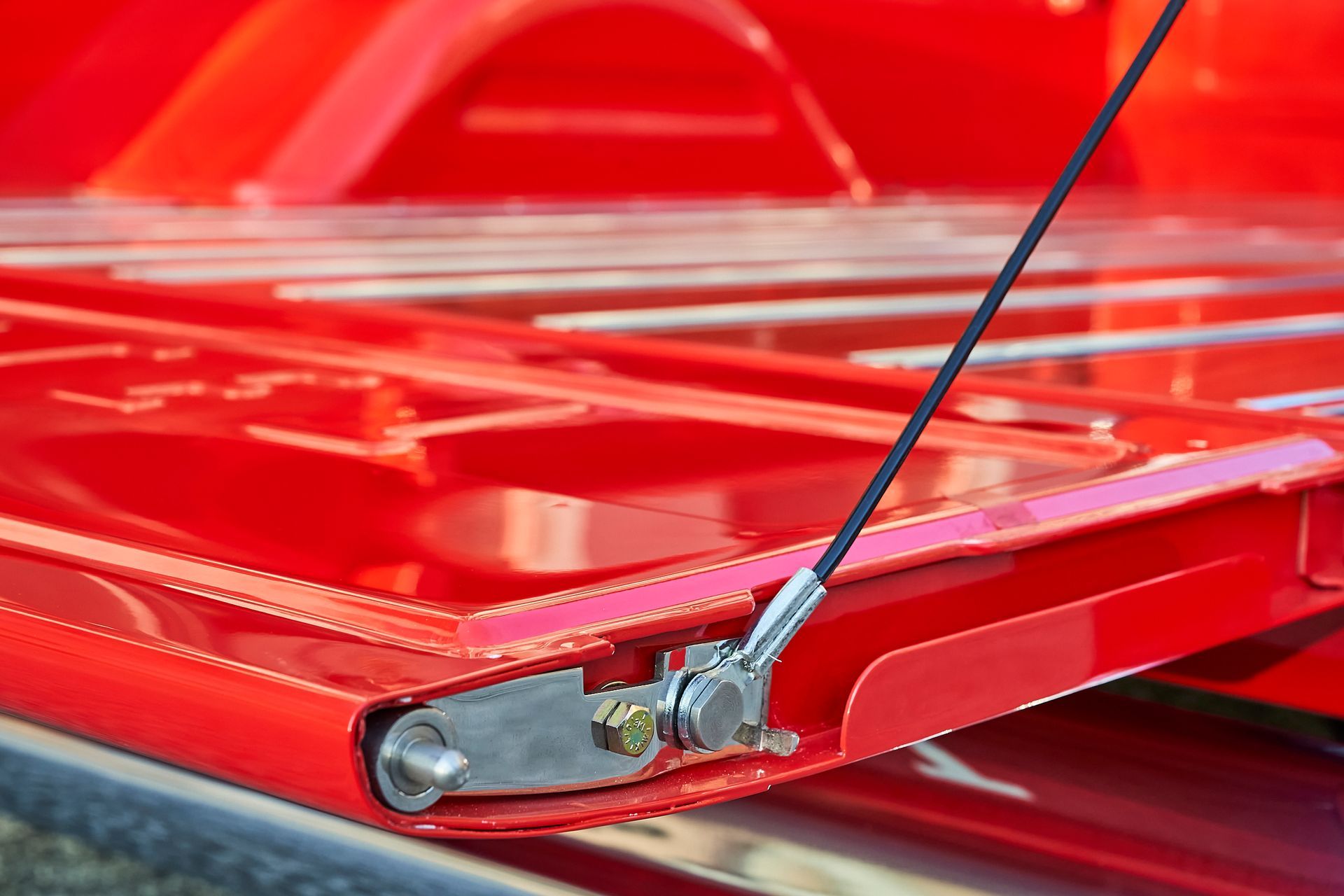 A close up of a red metal structure with a rope attached to it.