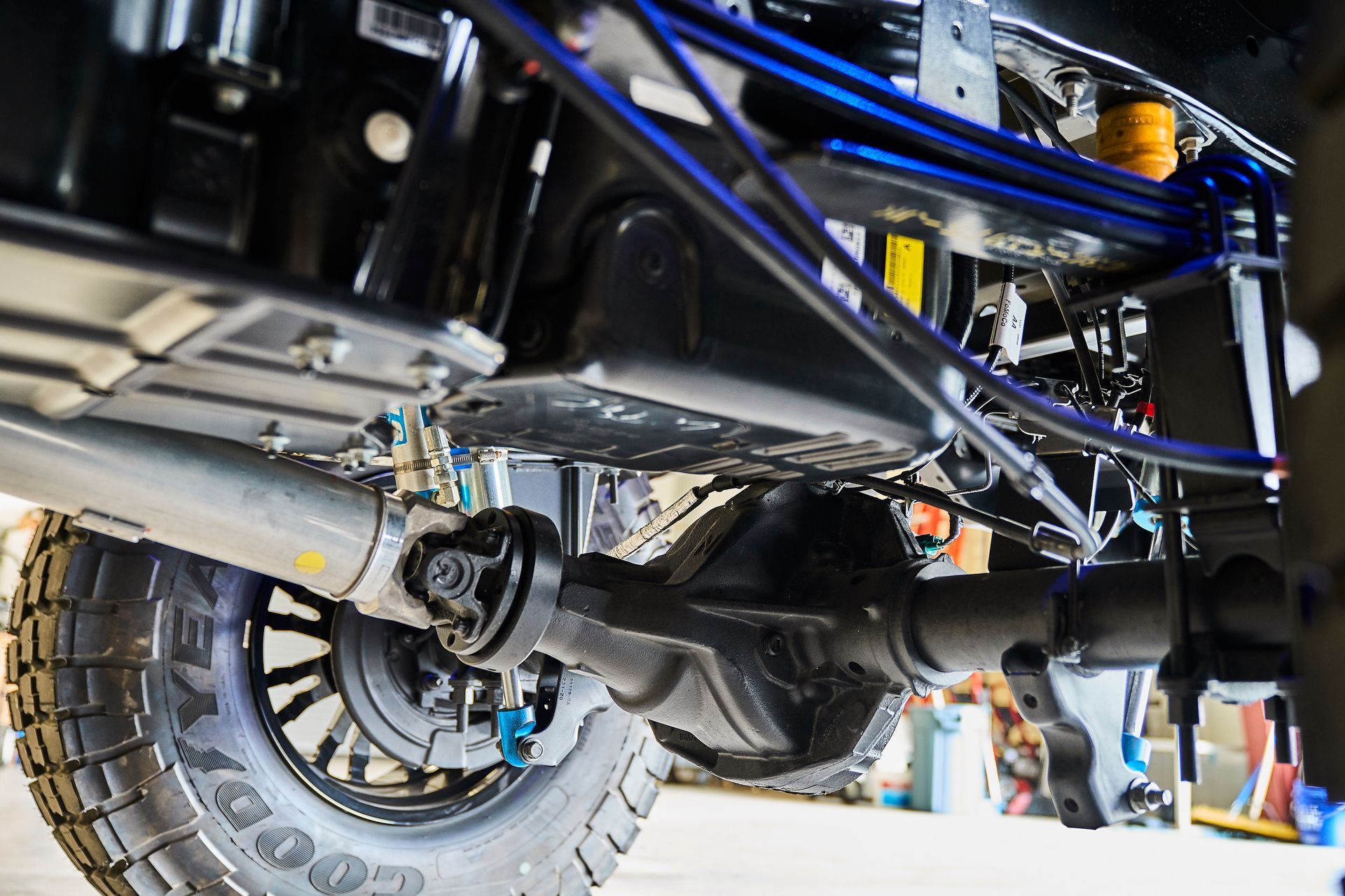 A close up of the underside of a truck with a tire on it.