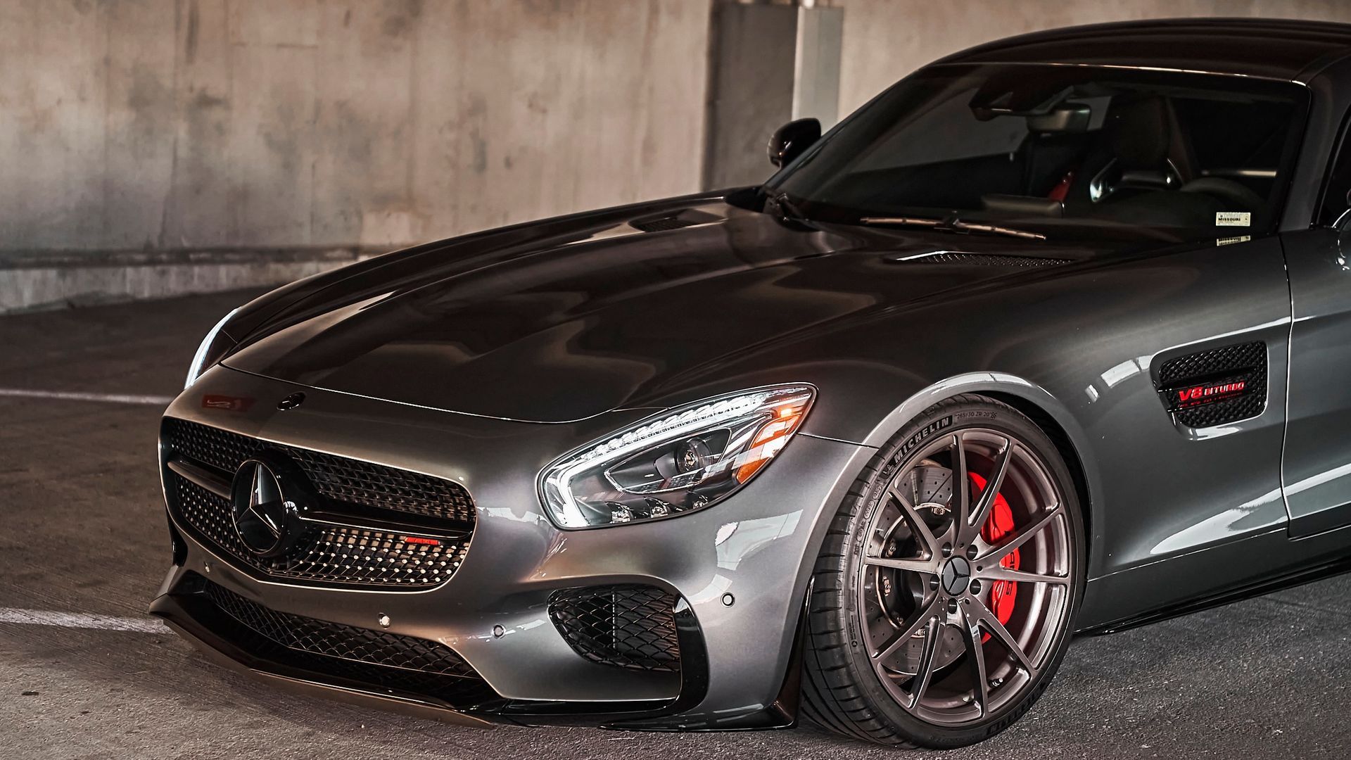 A mercedes amg gt is parked in a parking garage.