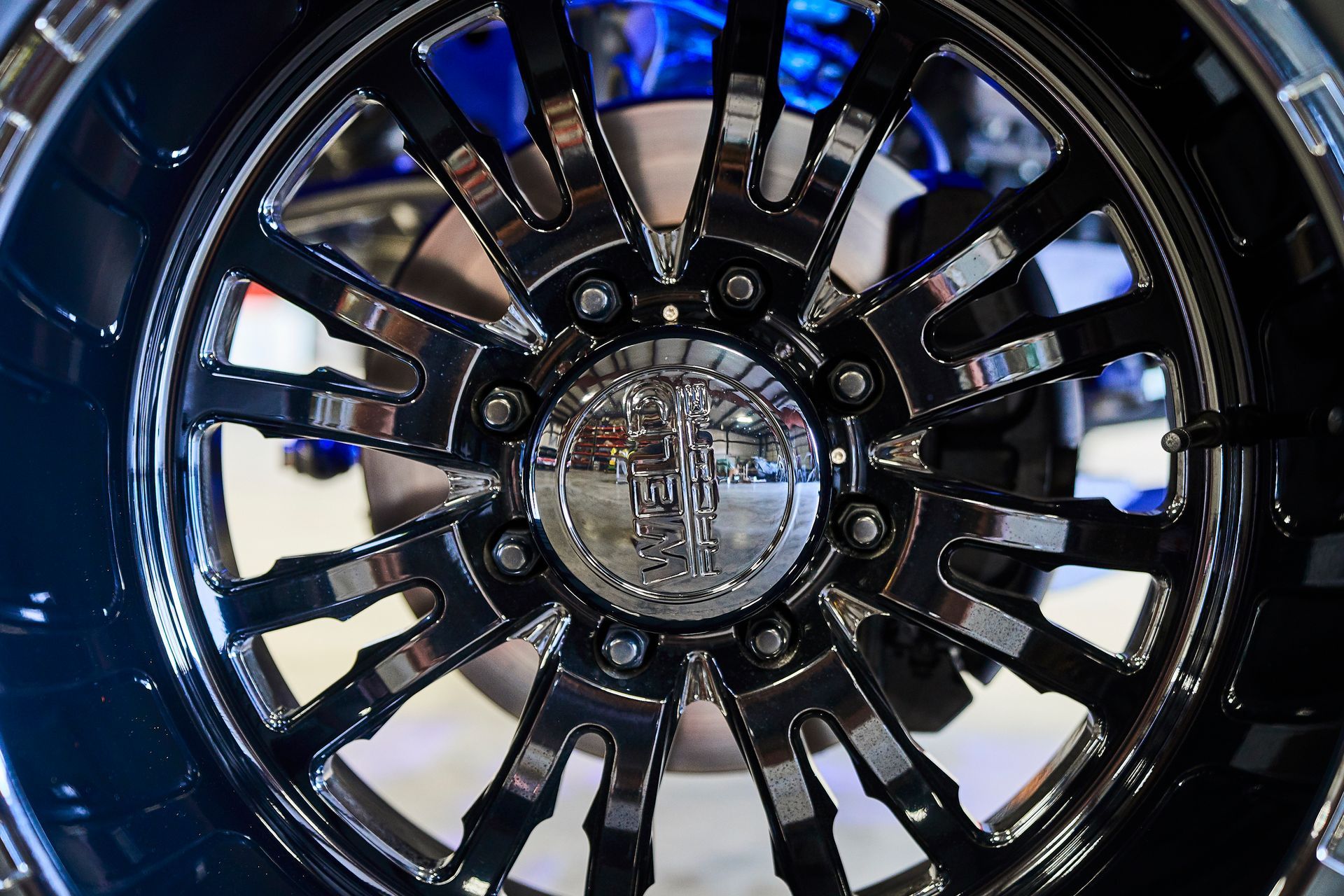 A close up of a black wheel with a silver center
