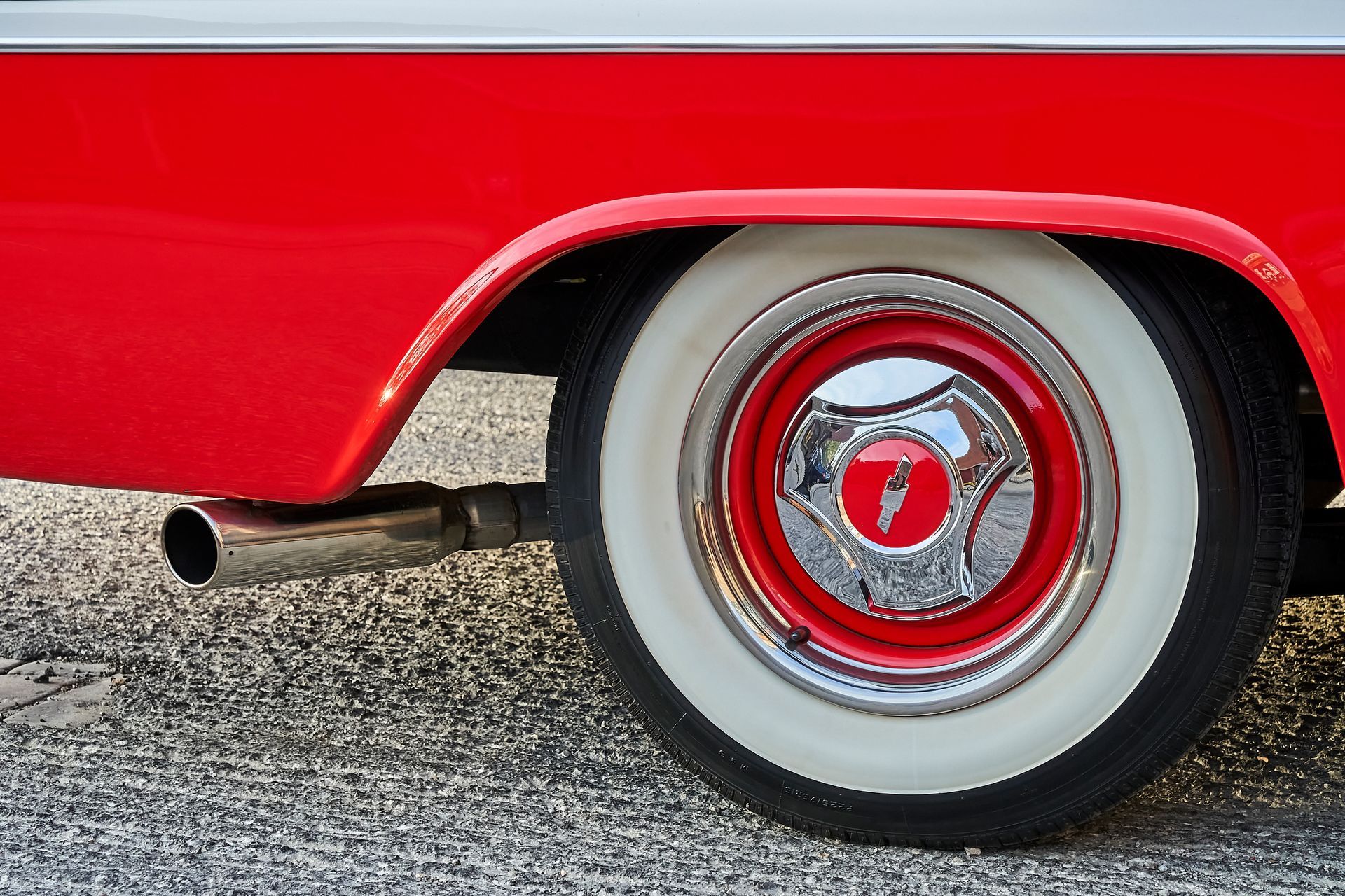A red car with white tires and a red rim