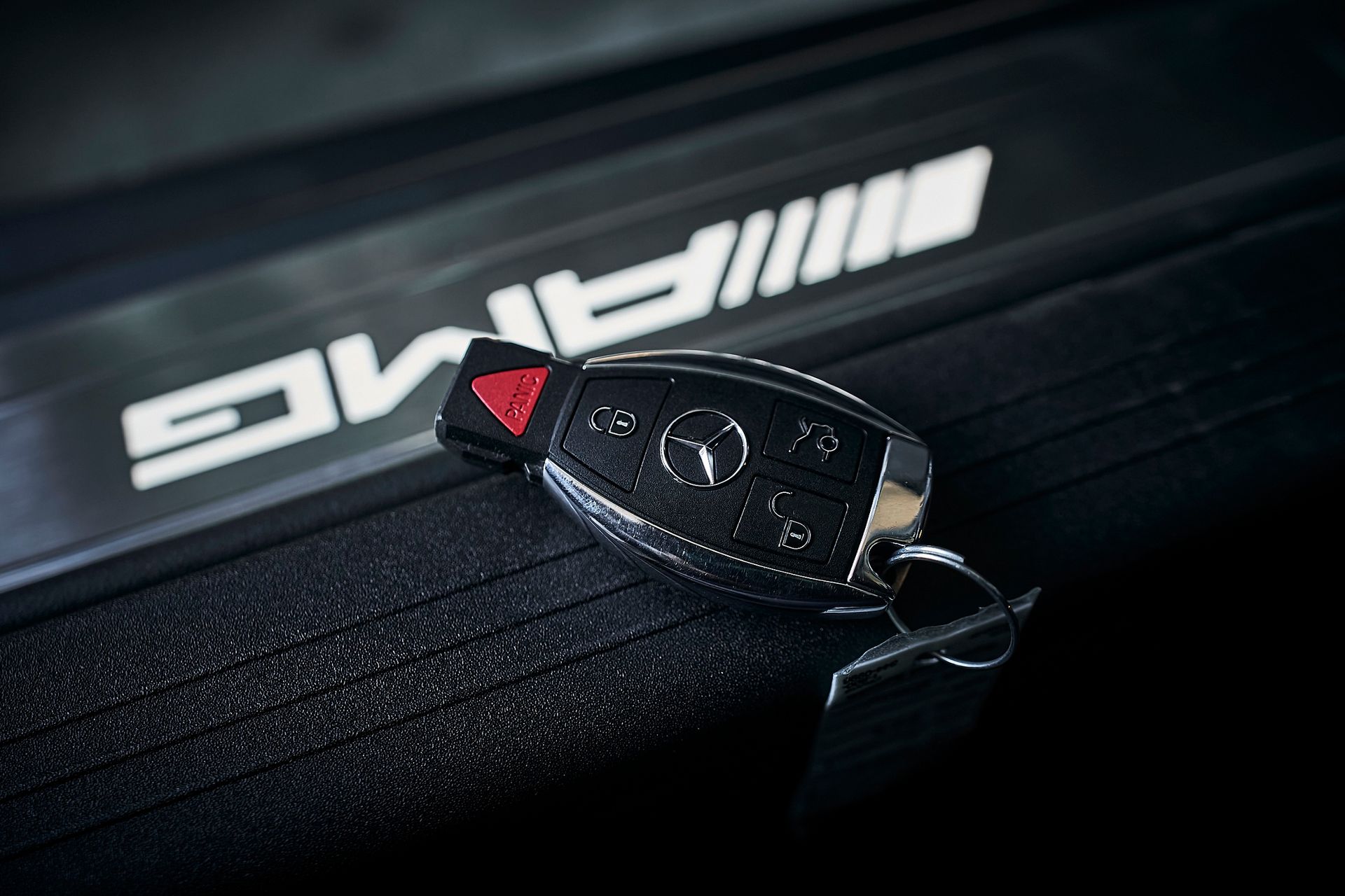 A close up of a mercedes amg car key