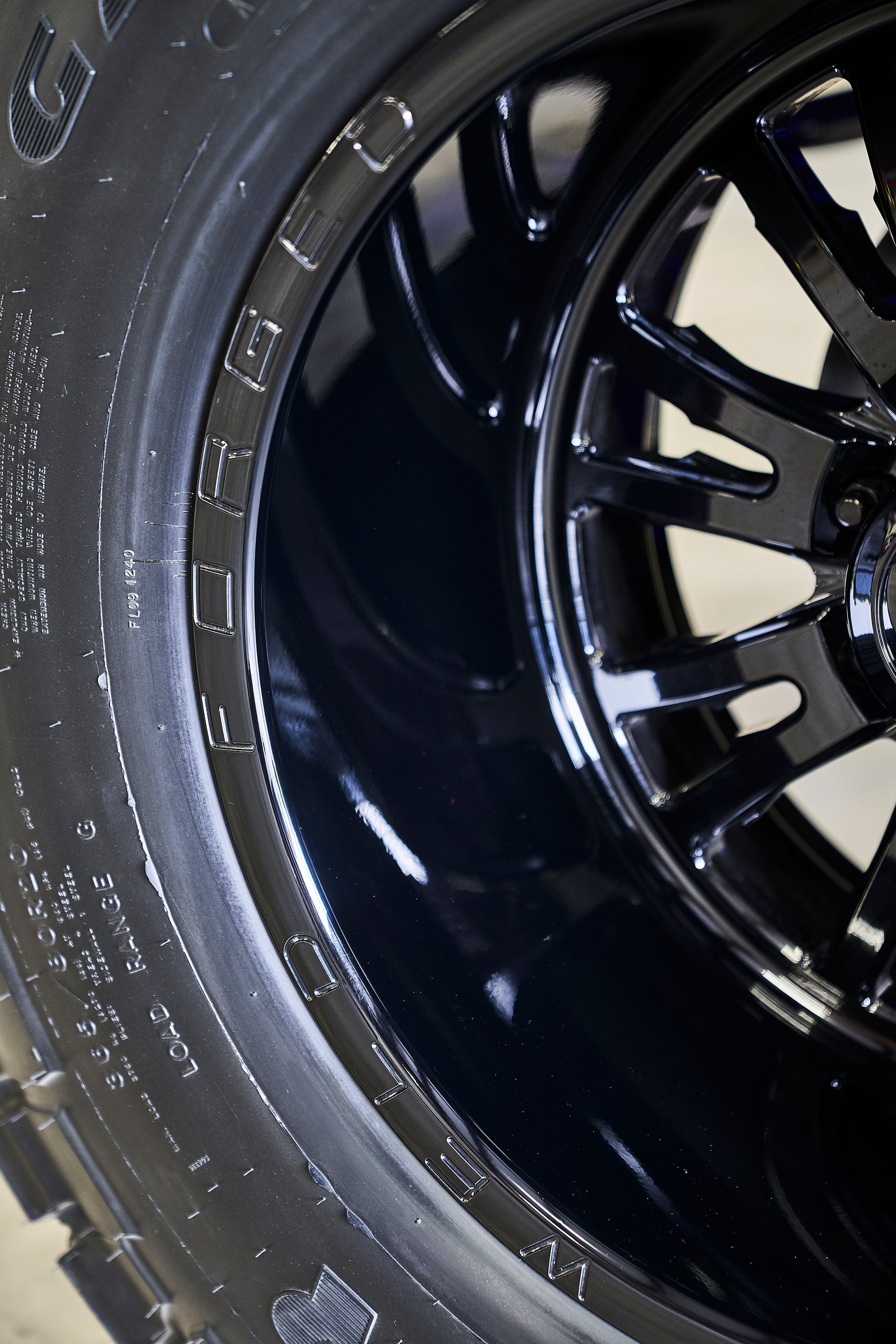 A close up of a black tire on a black rim