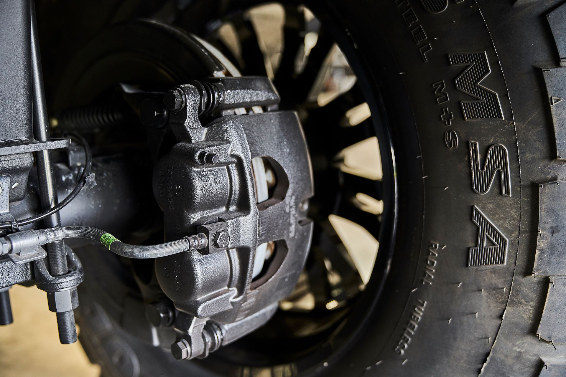 A close up of a tire with a brake caliper on it