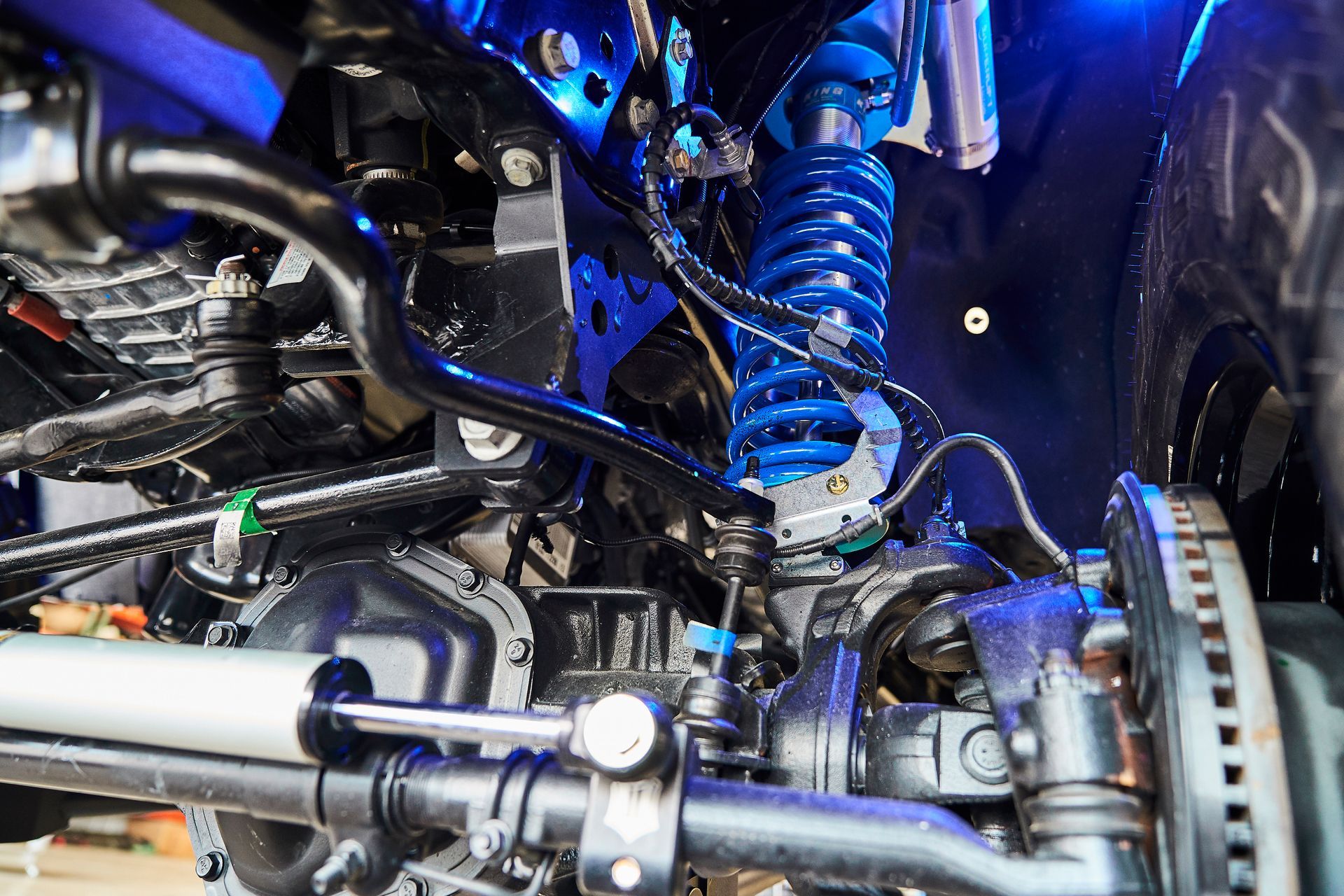 A close up of the underside of a car 's suspension system.