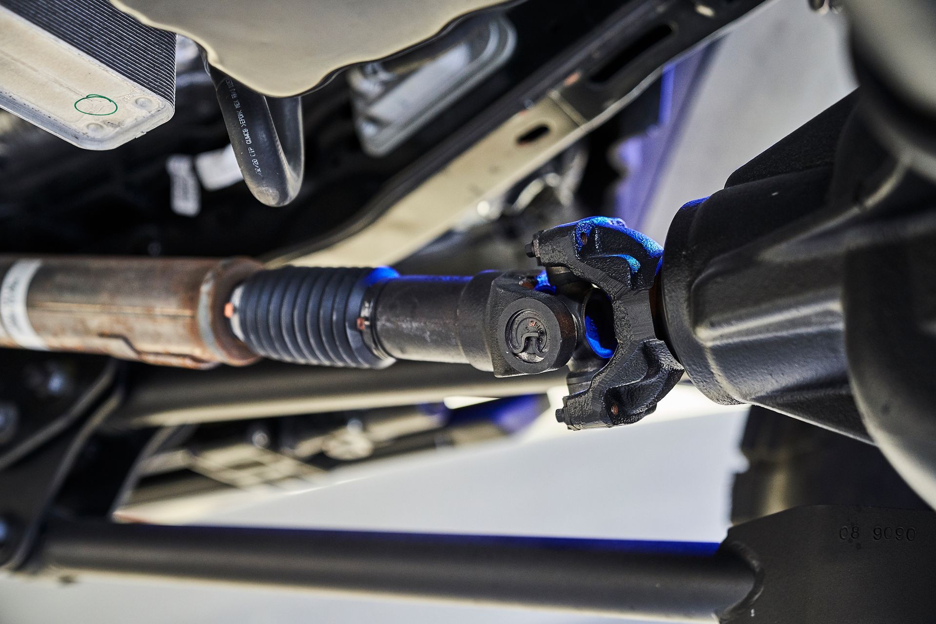 A close up of a drive shaft on a car.