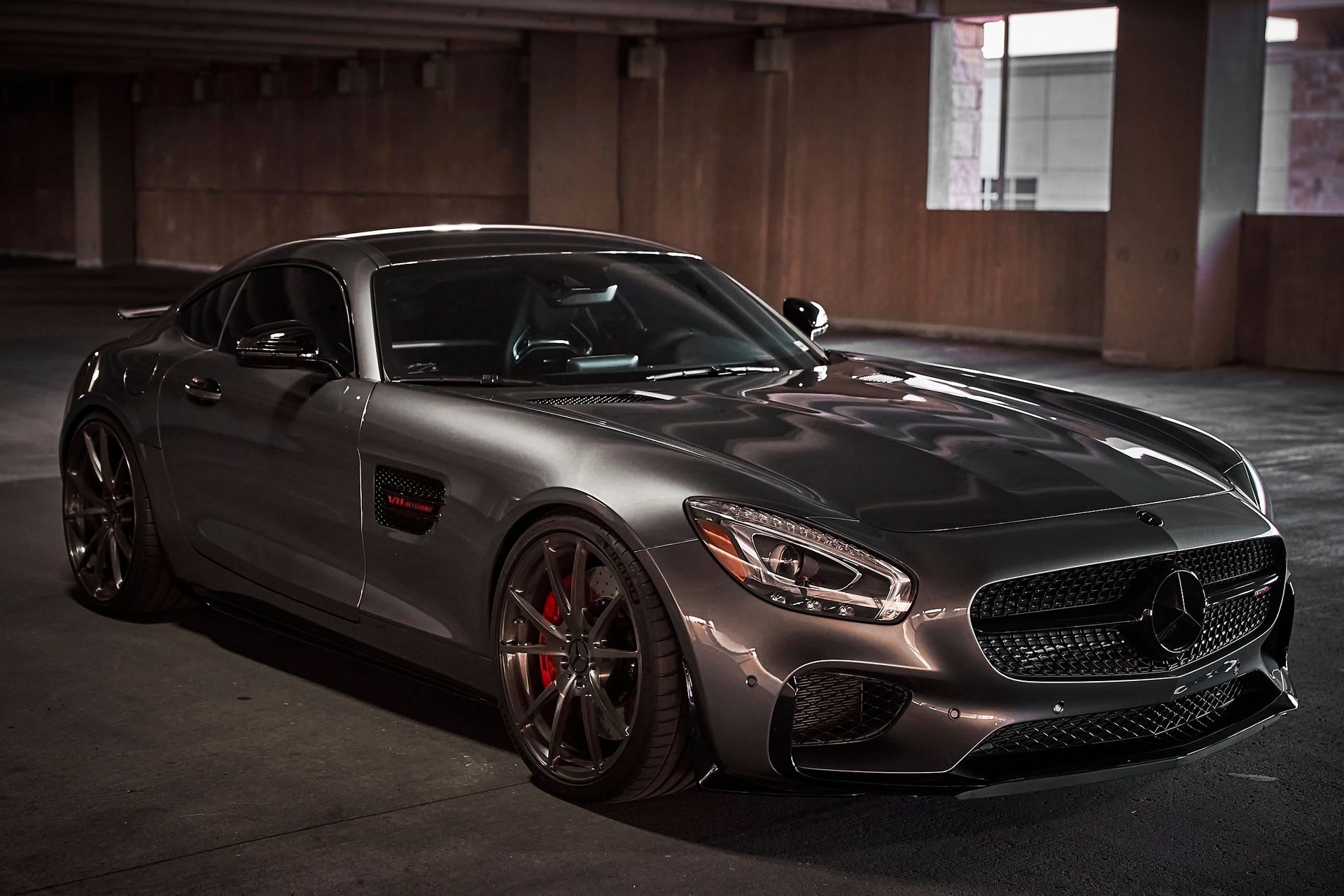 A mercedes benz amg gt is parked in a parking garage.