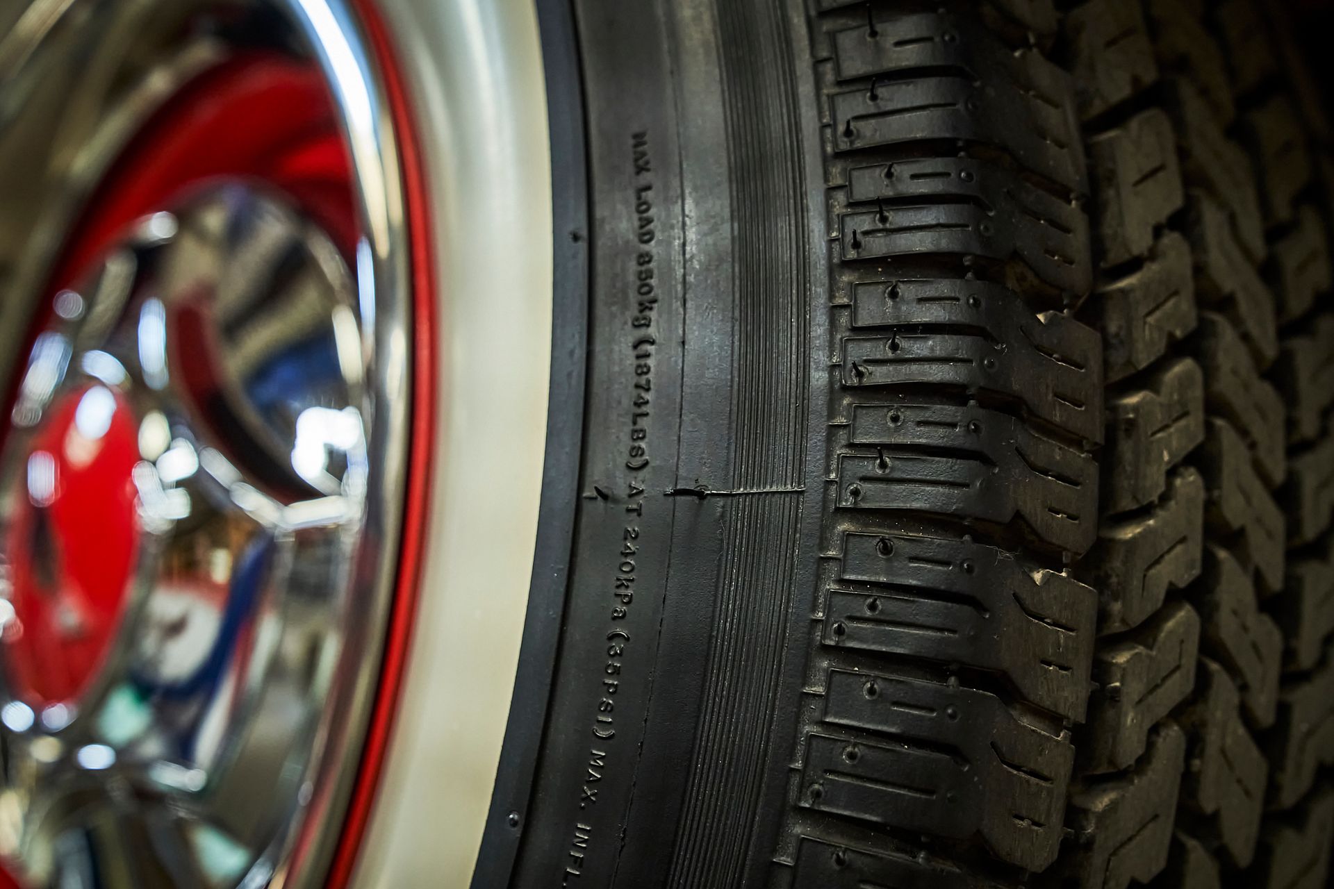 A close up of a tire with a red rim