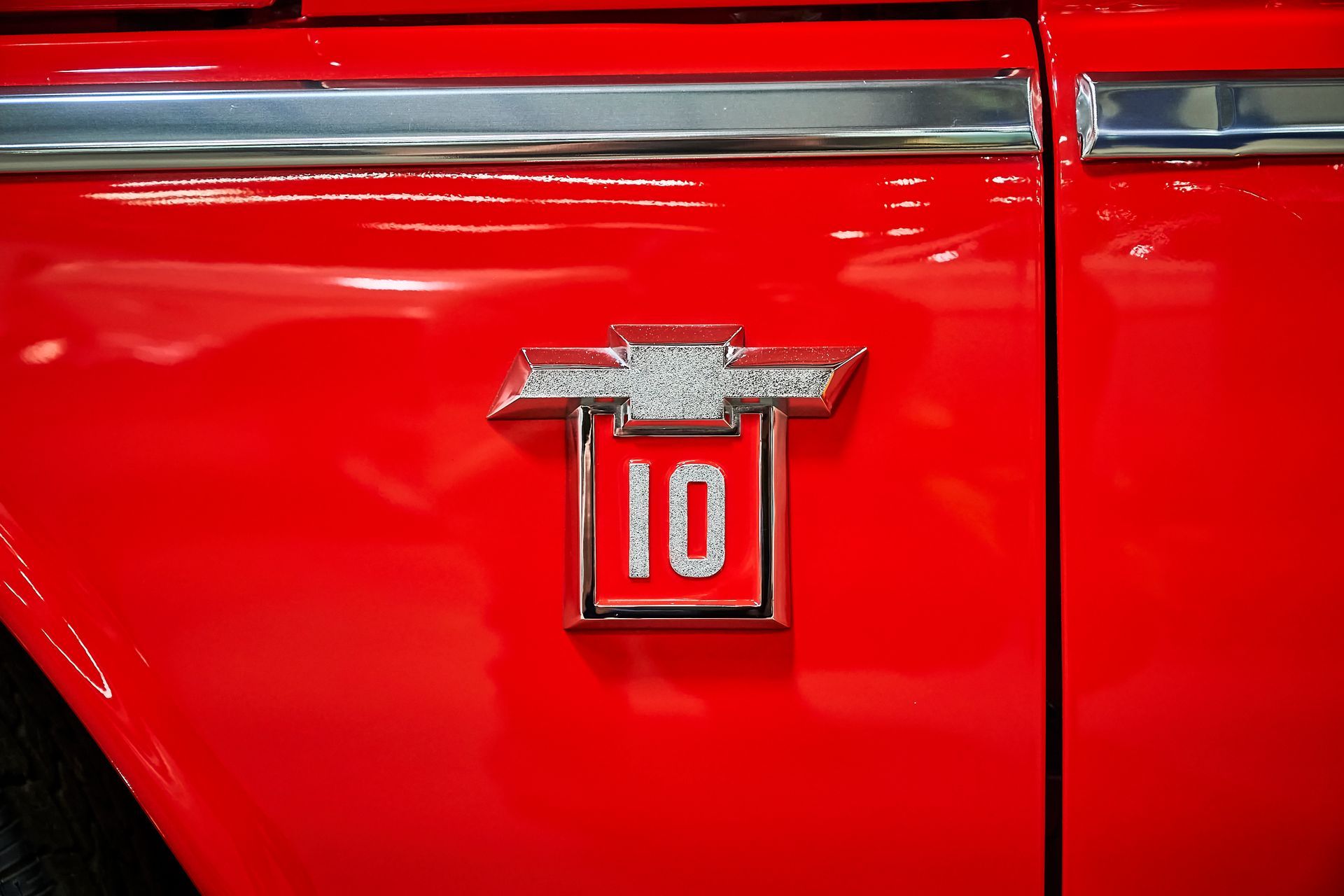 A red chevrolet truck with the number 10 on the side of it.