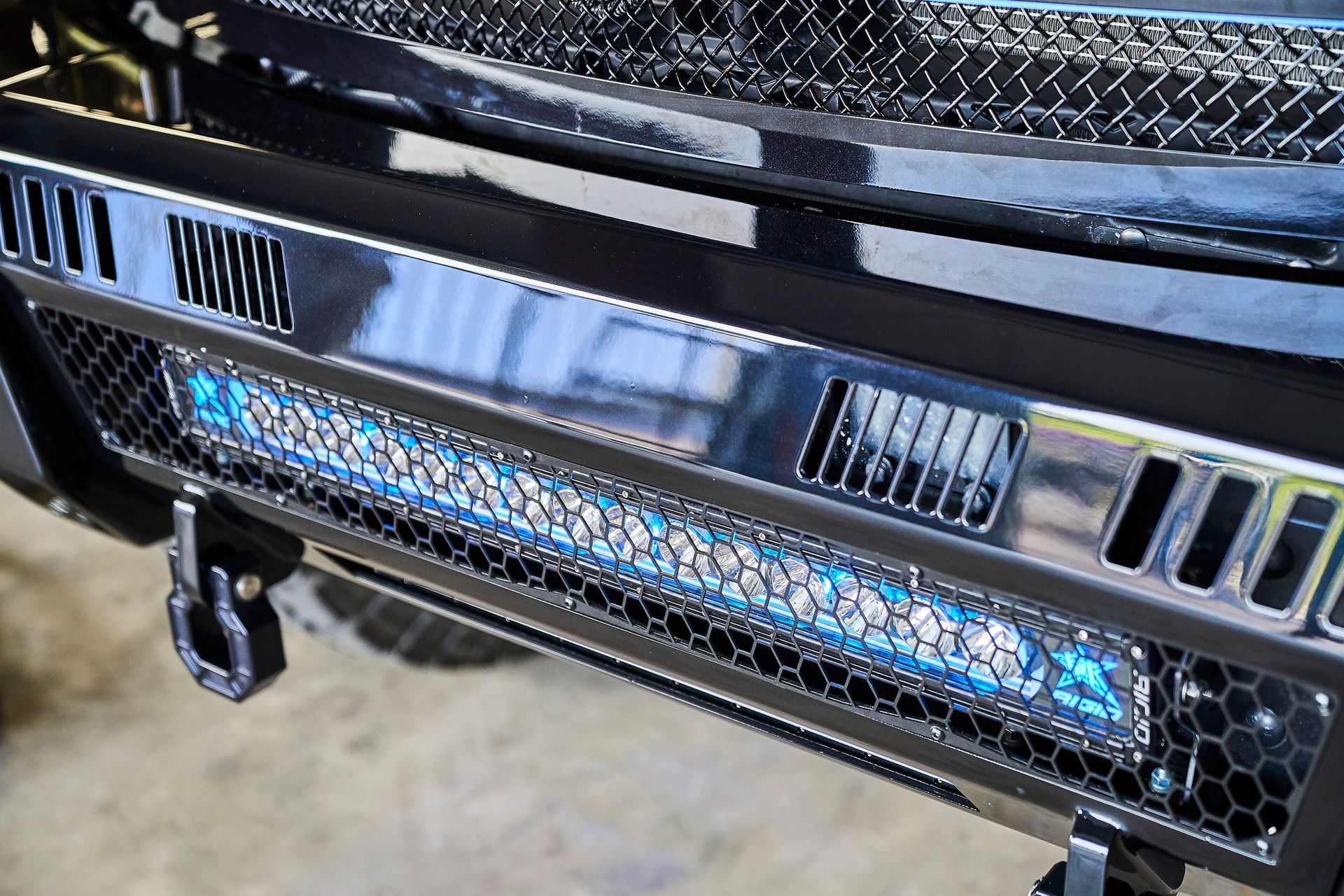 A close up of the front bumper of a truck with a light bar.