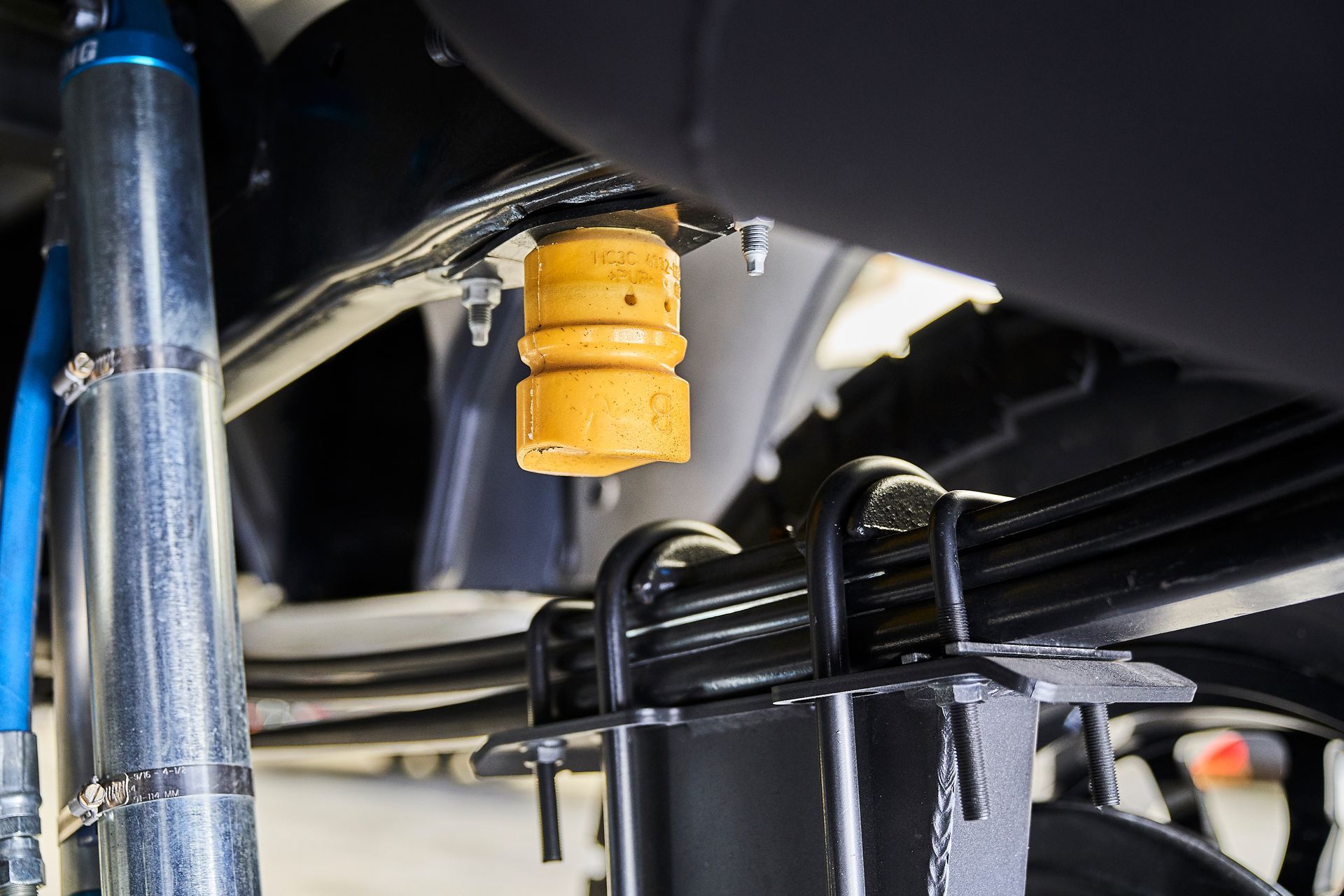 A close up of a shock absorber on a car.