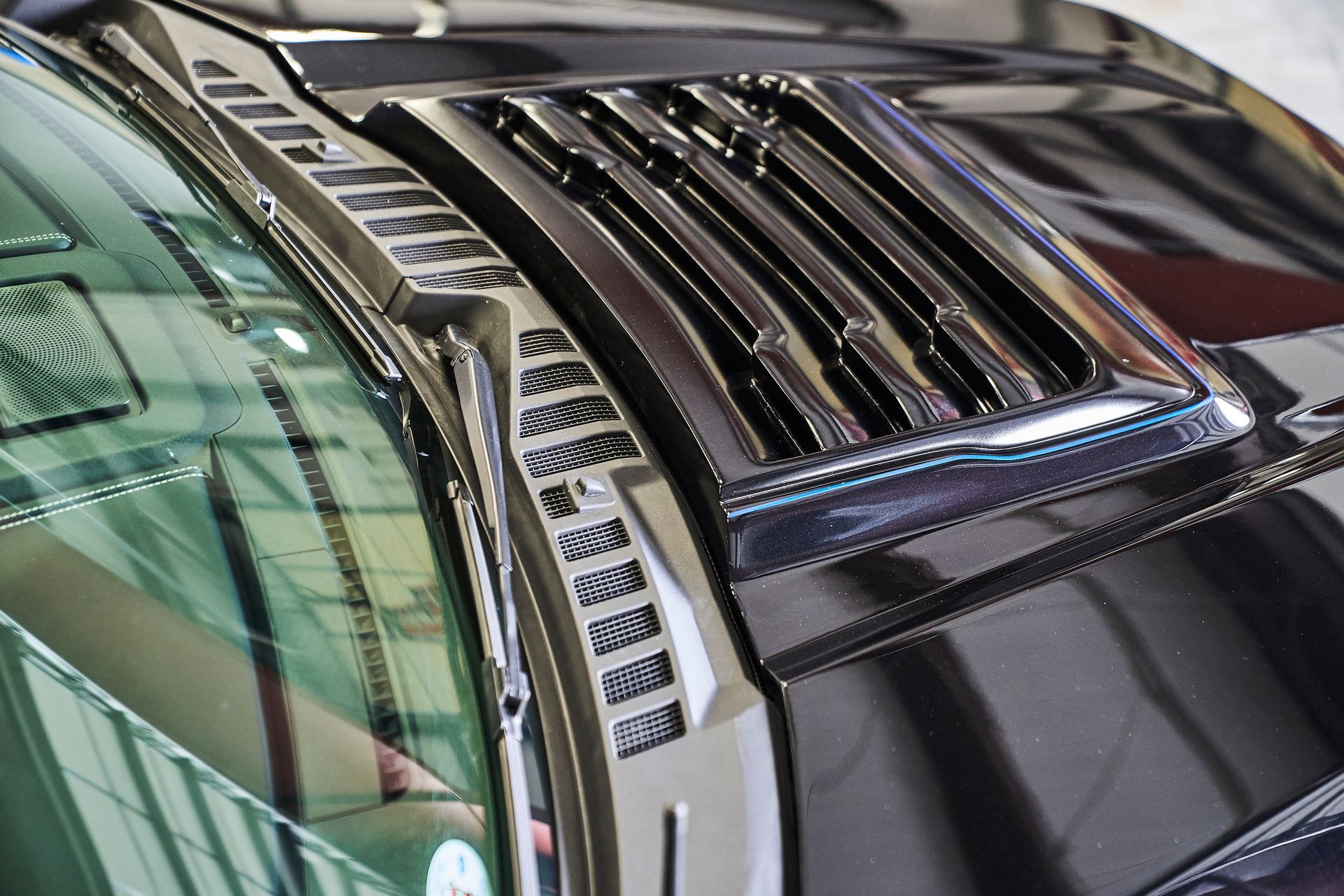 A close up of the hood of a black car