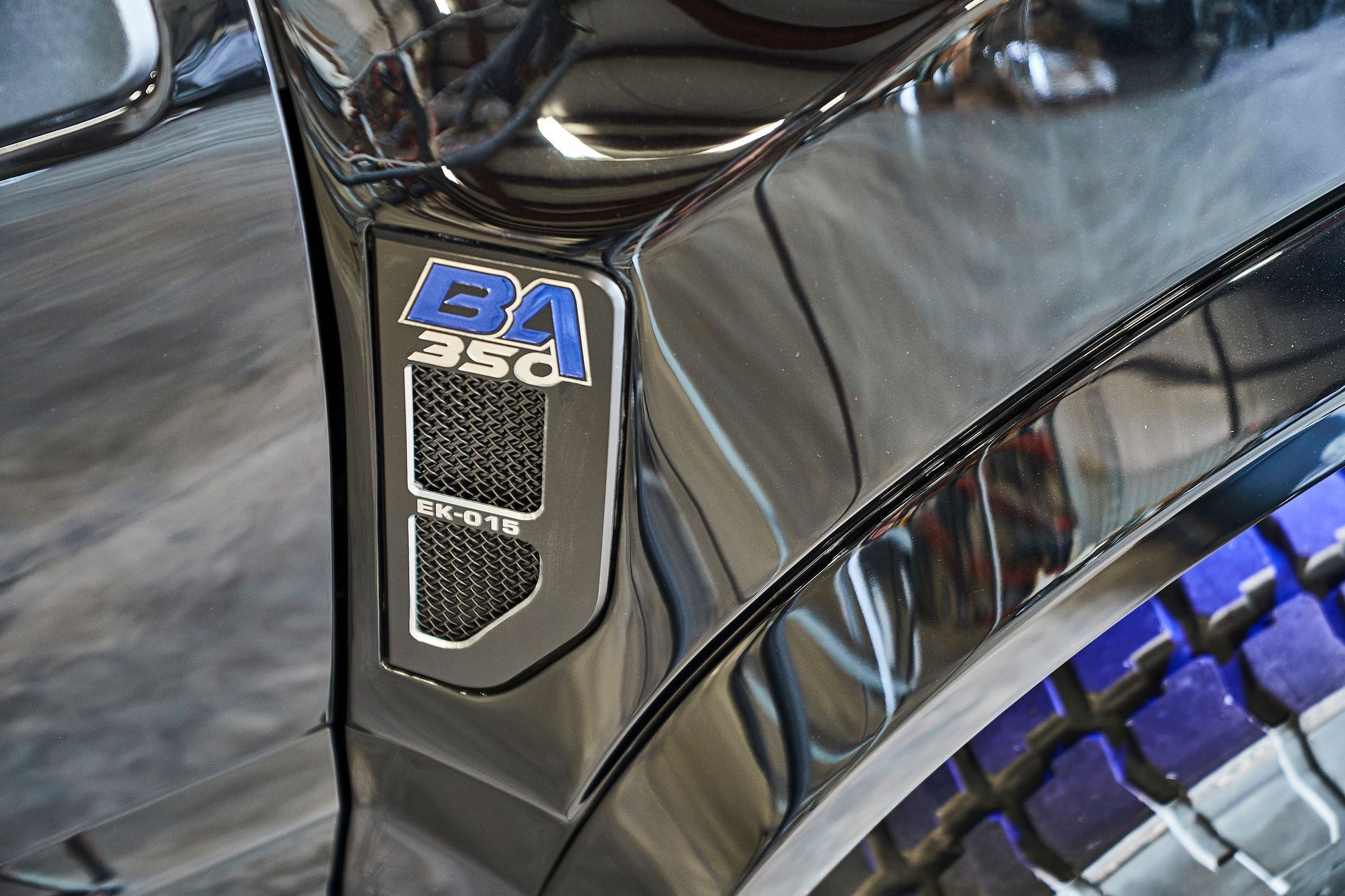 A close up of a black car with a badge that says ba 350