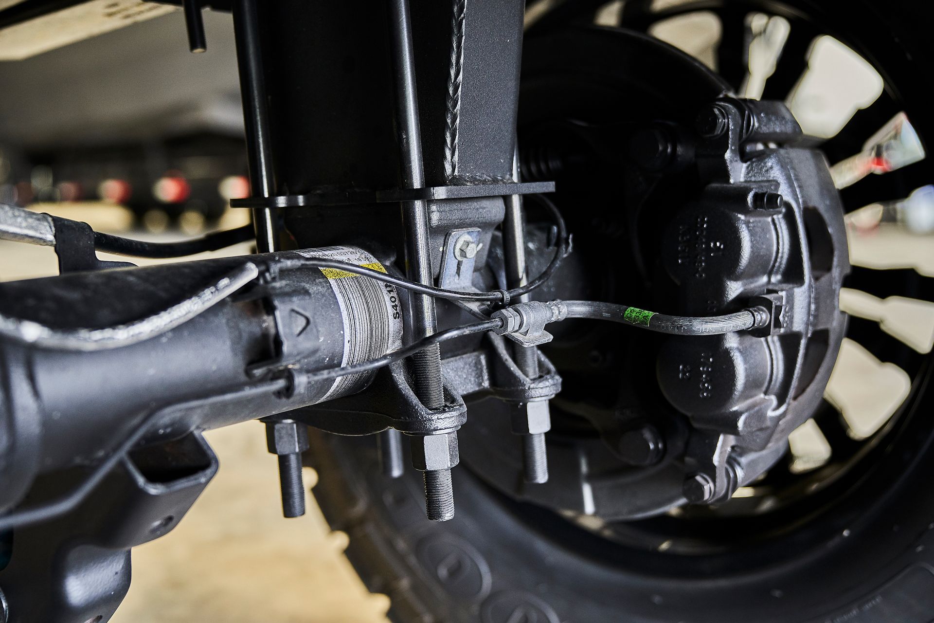 A close up of a rear axle of a vehicle