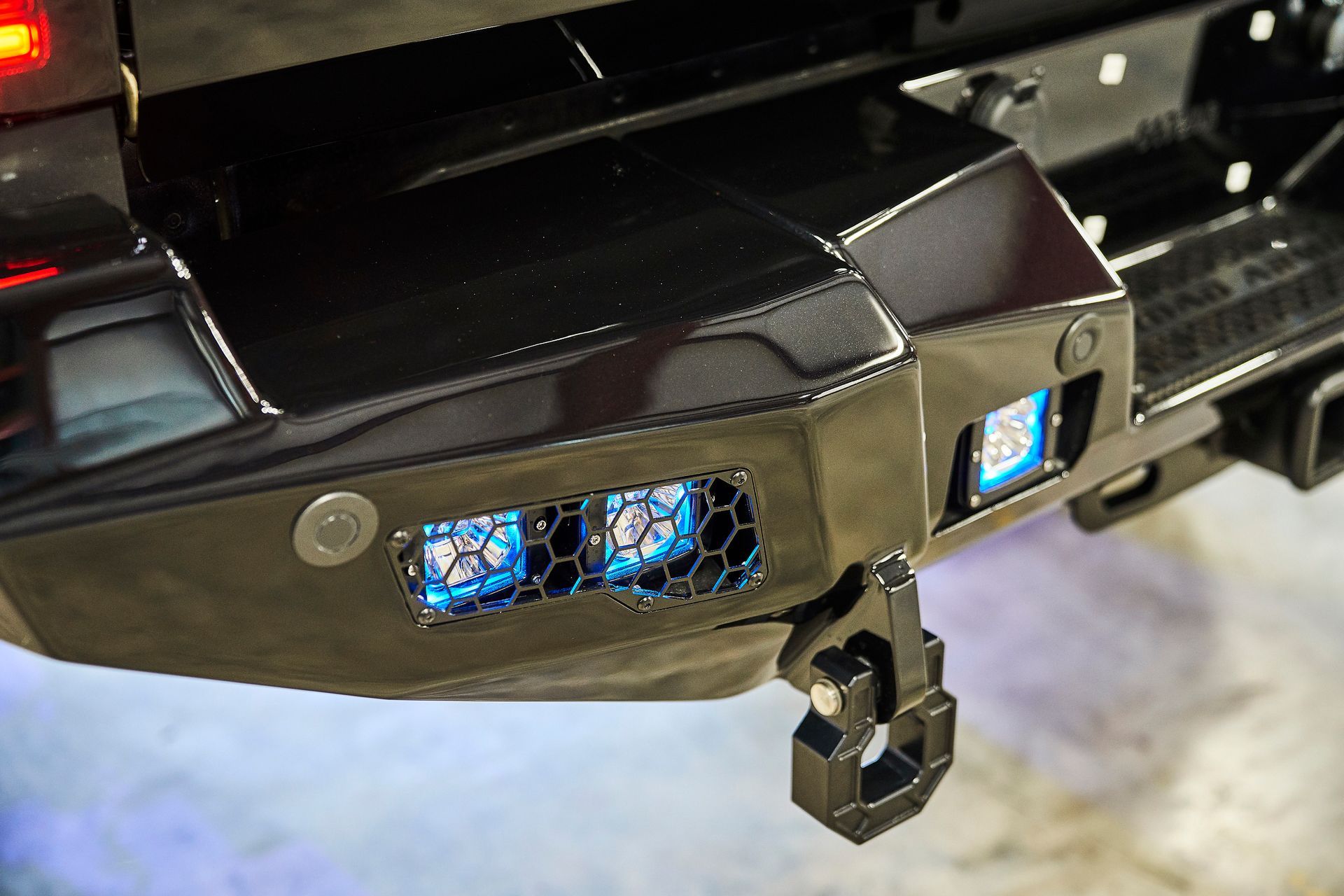 A close up of the back bumper of a truck with lights on it.