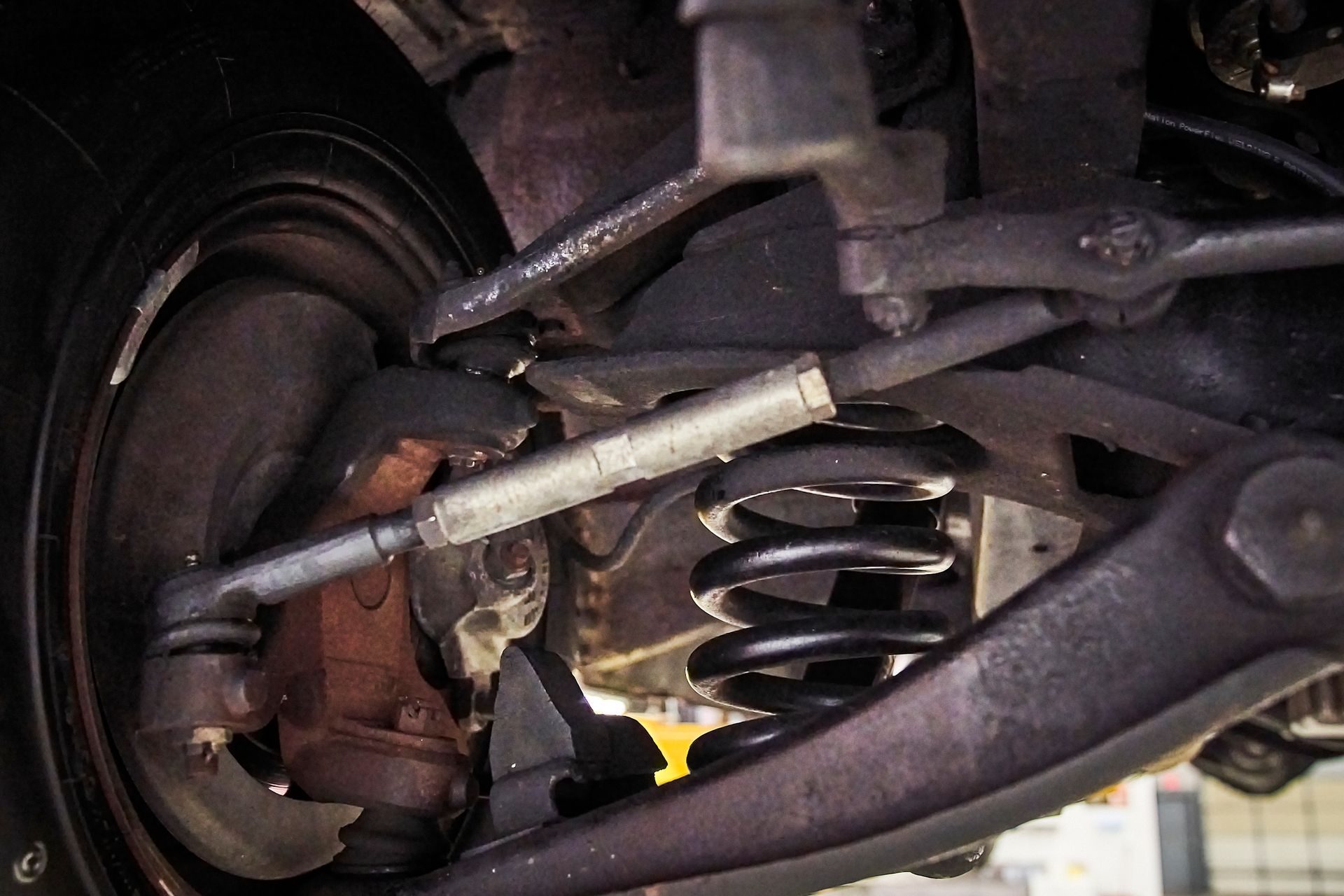 A close up of the underside of a car 's suspension system.