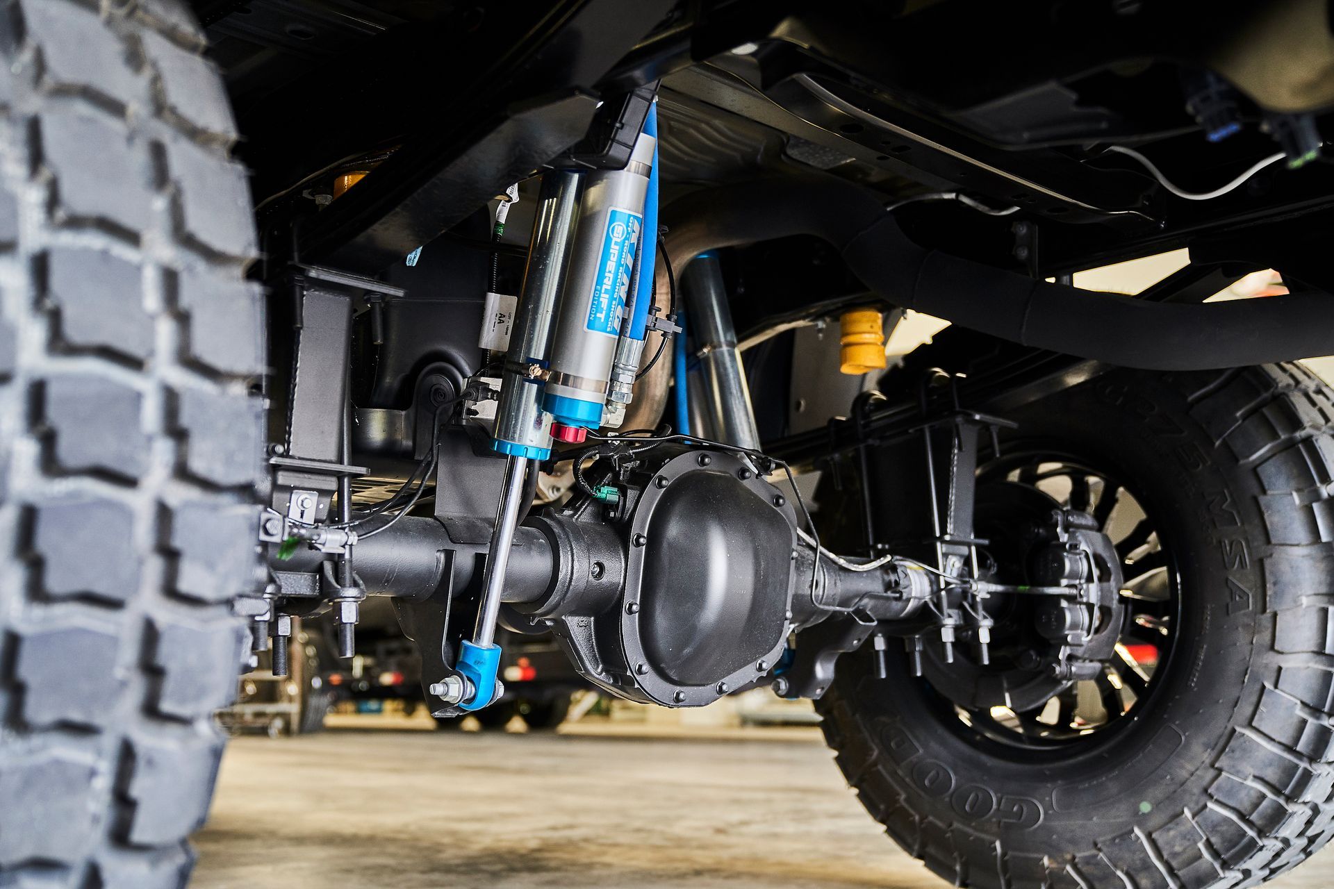 A close up of the underside of a truck 's suspension system.