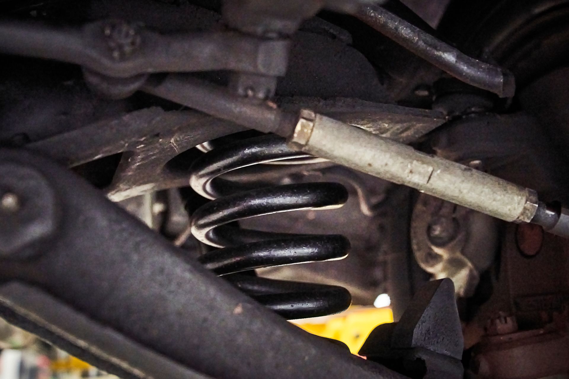 A close up of a shock absorber on a car.