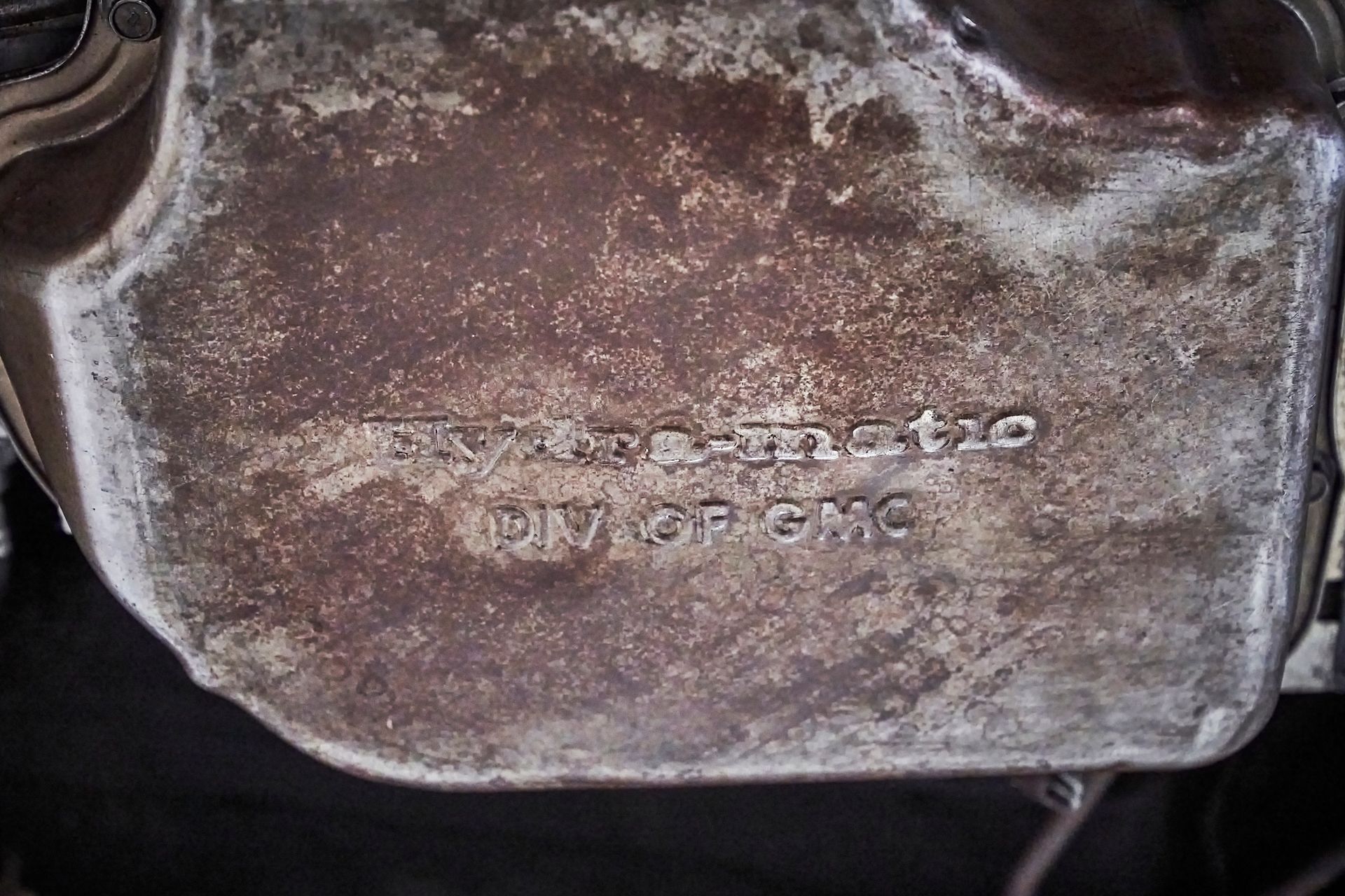 A close up of a rusty metal object with the word dynamo written on it