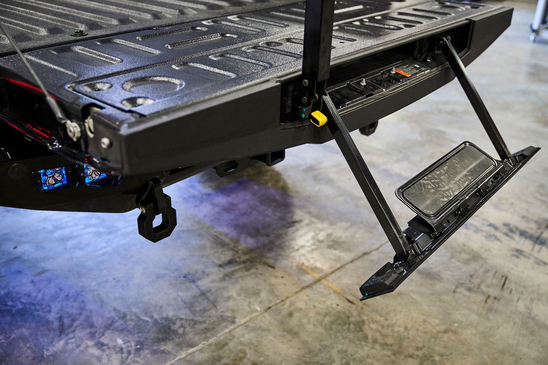 A close up of a truck with a step on the back of it.