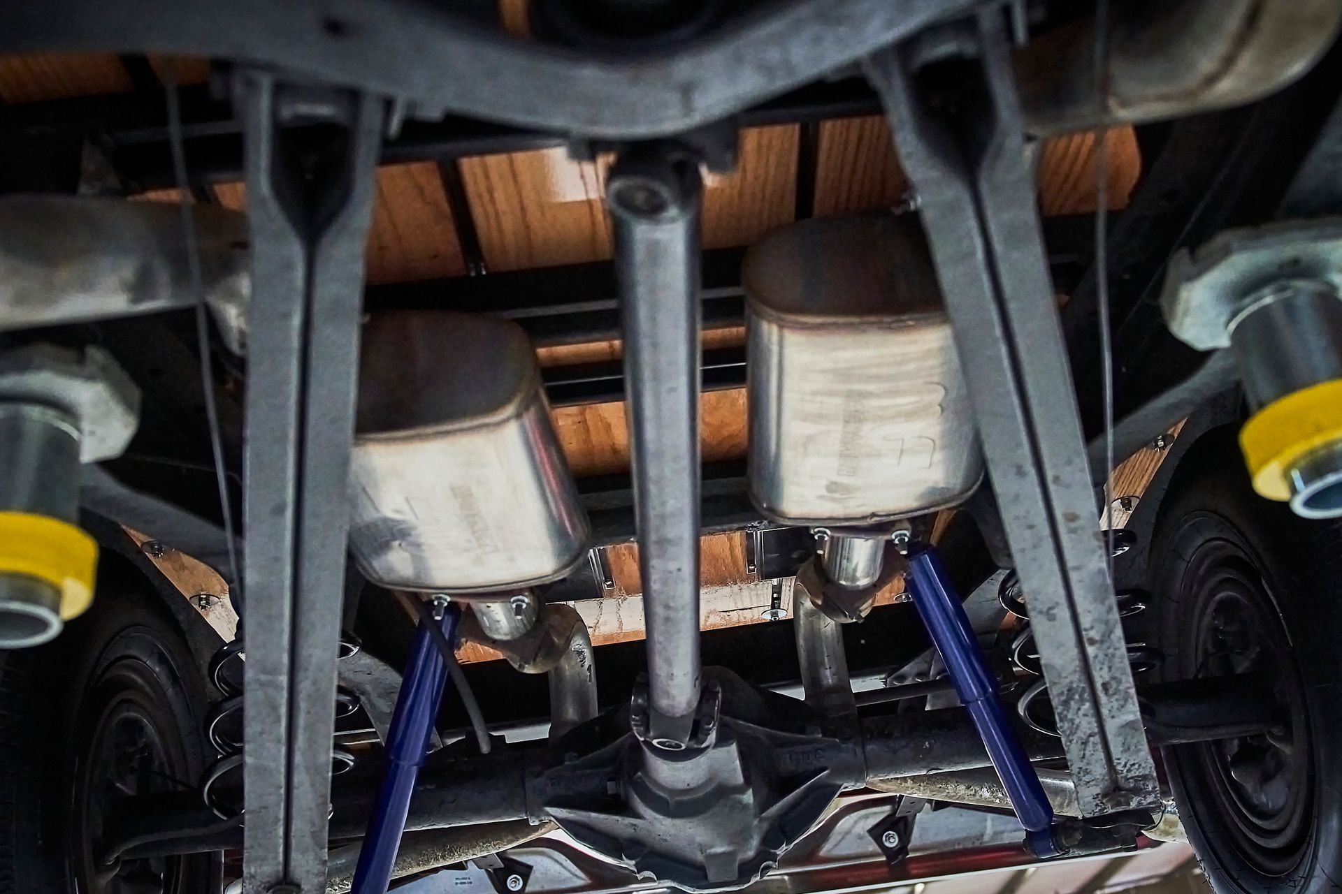 A close up of the underside of a truck with exhaust pipes