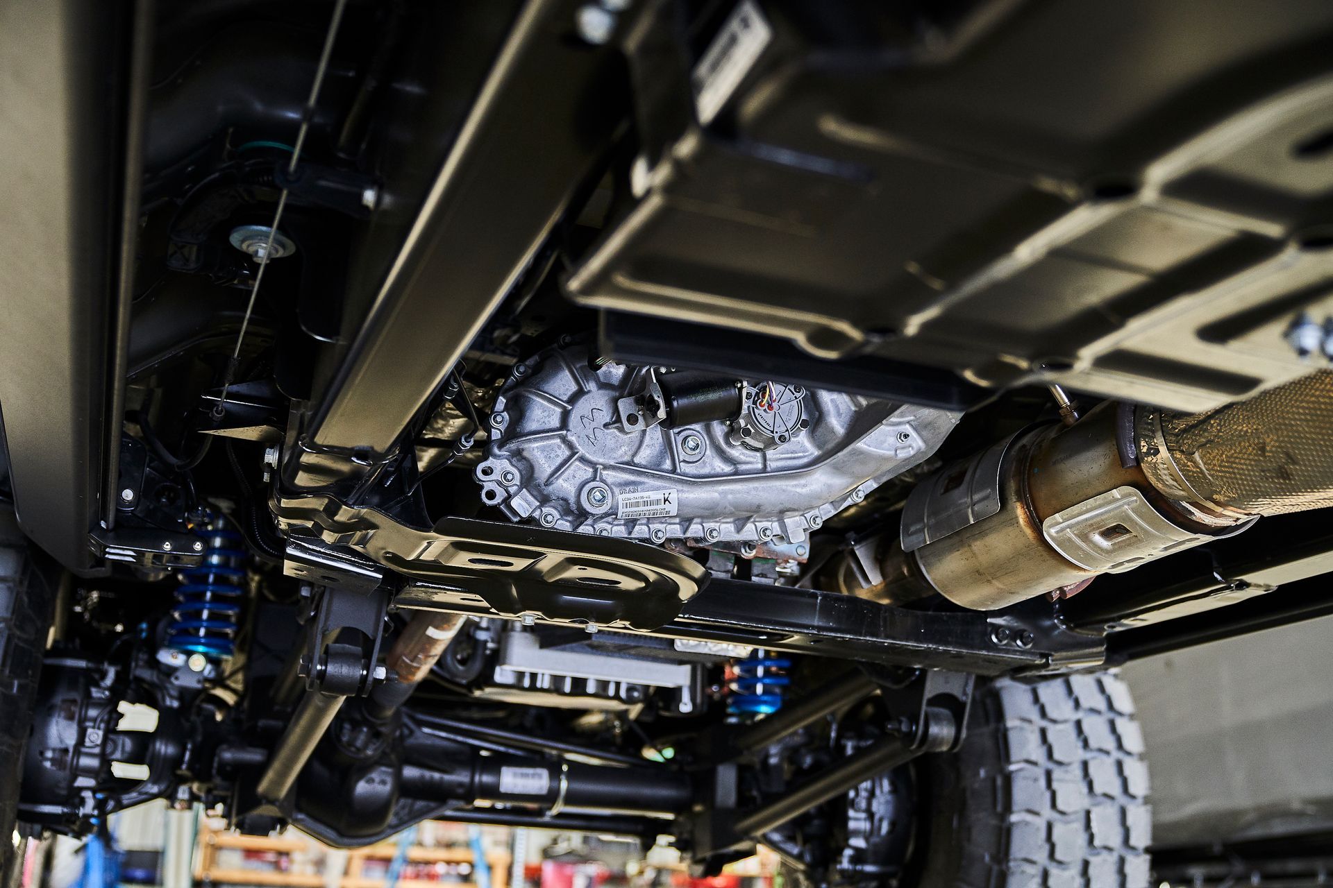 A close up of the underside of a car in a garage.