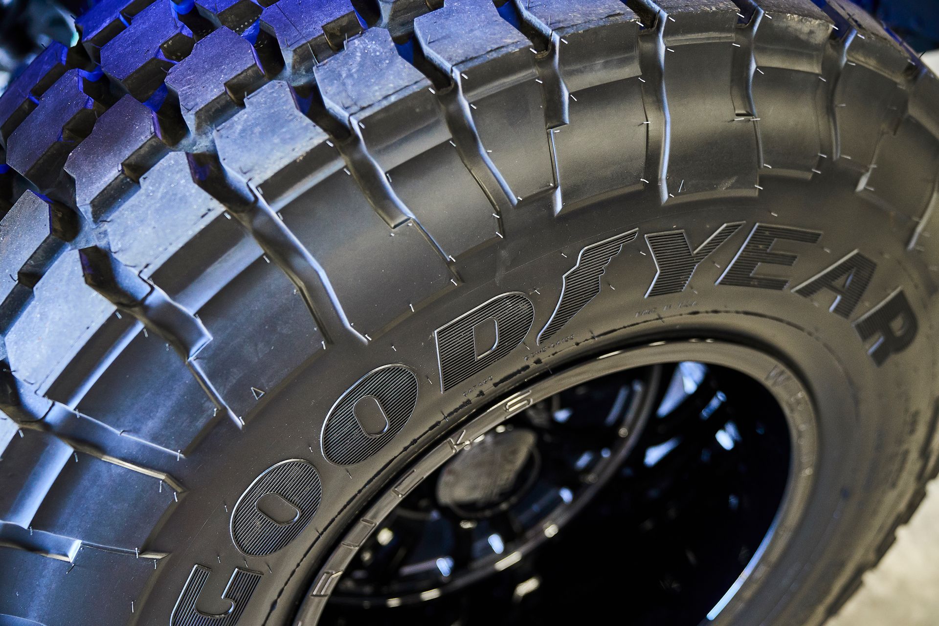 A close up of a good year tire on a black wheel