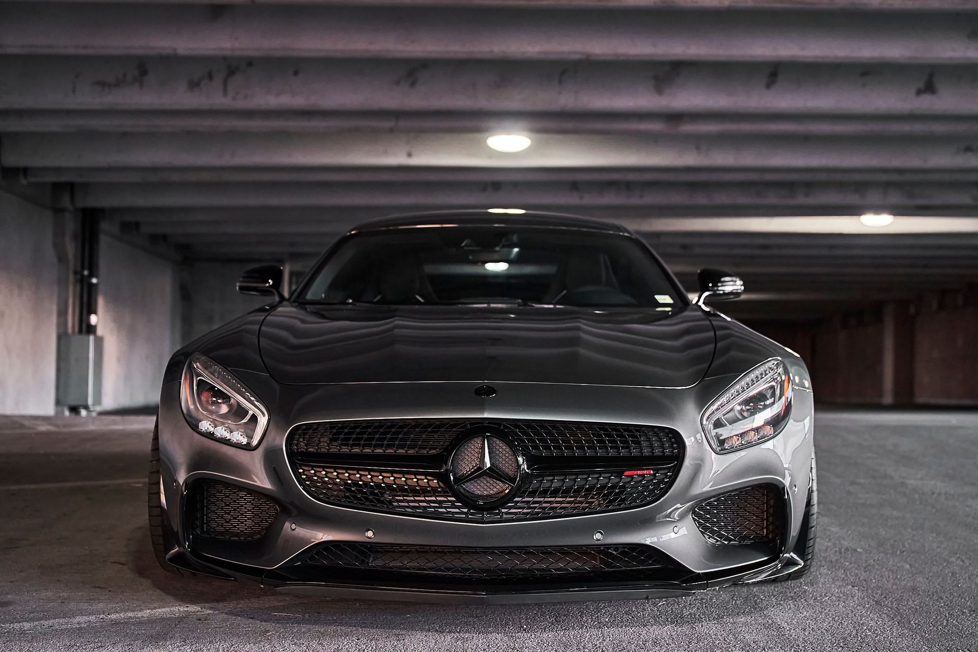 A mercedes benz amg gt is parked in a parking garage.
