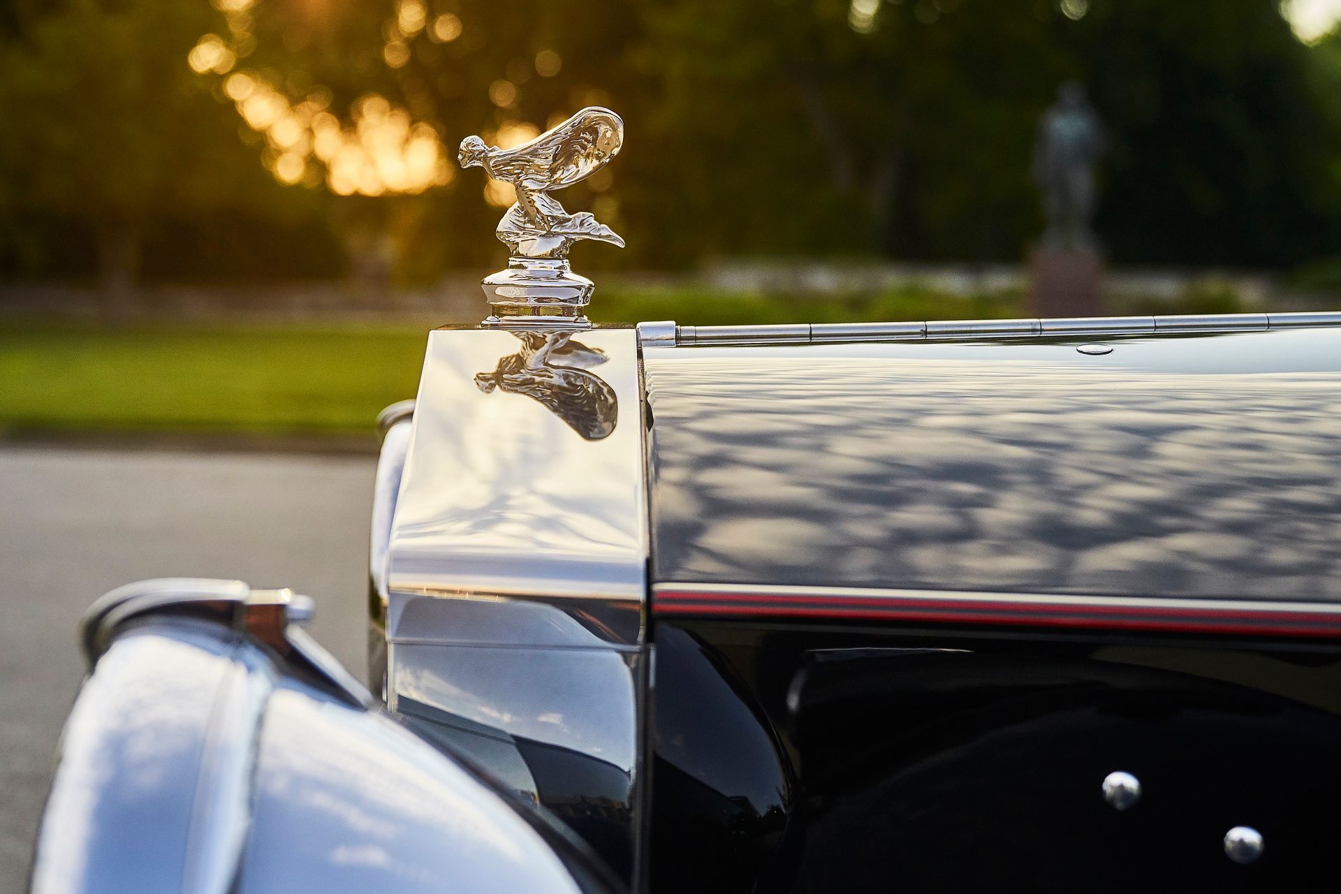 A close up of a car with a hood ornament on it.