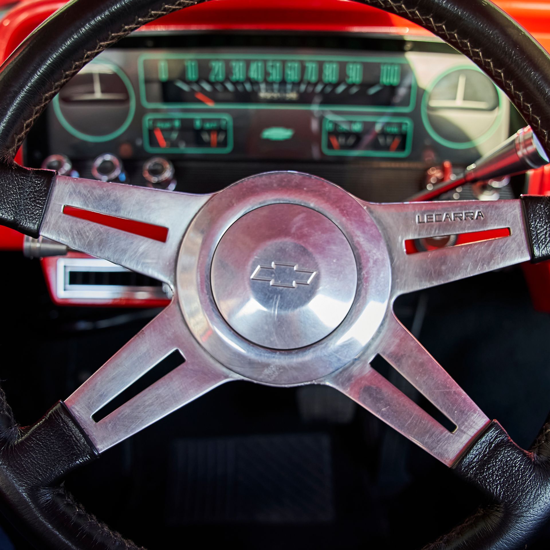 A close up of a steering wheel with the word chevrolet on it