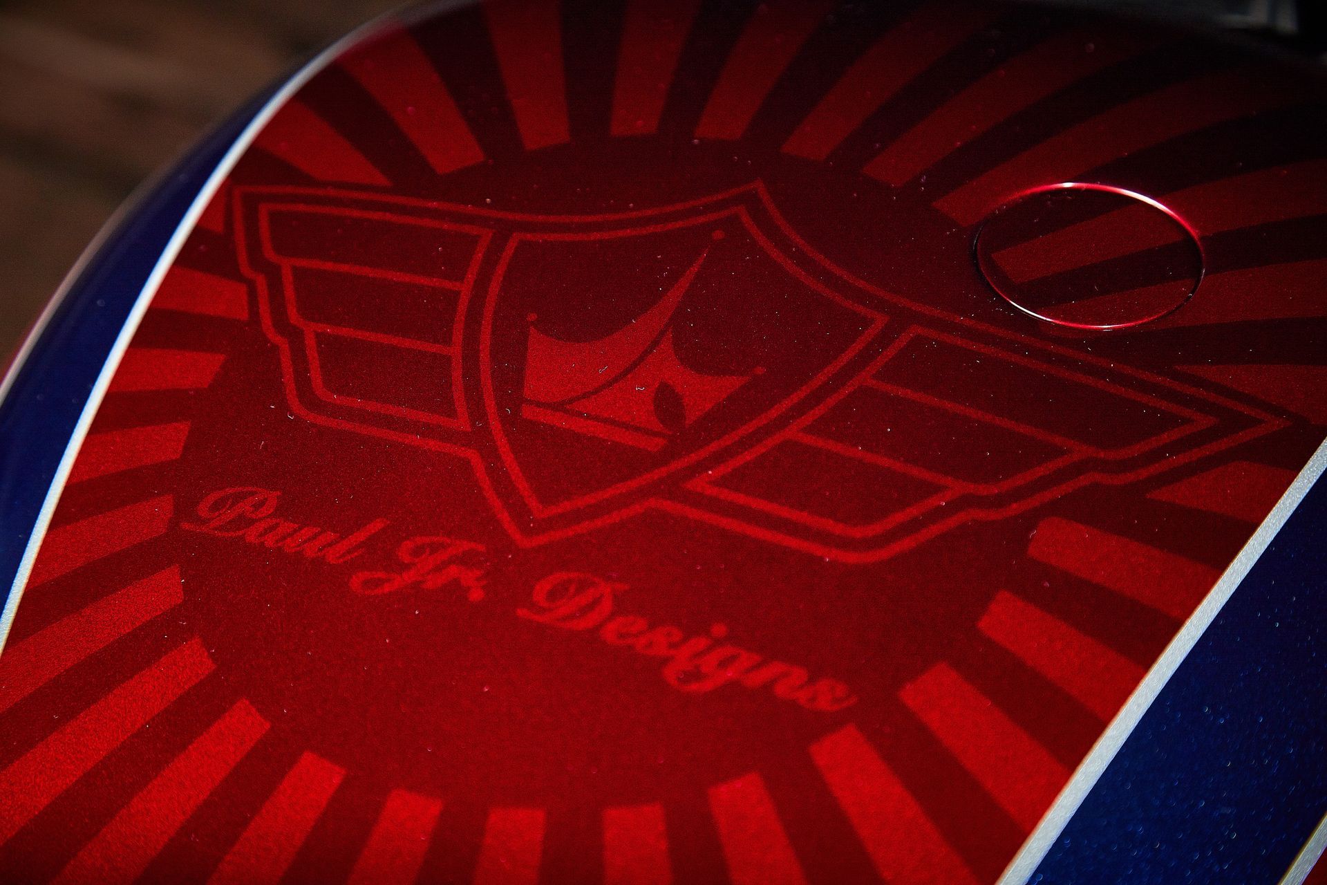 A close up of a red and blue helmet with paul jr designs written on it