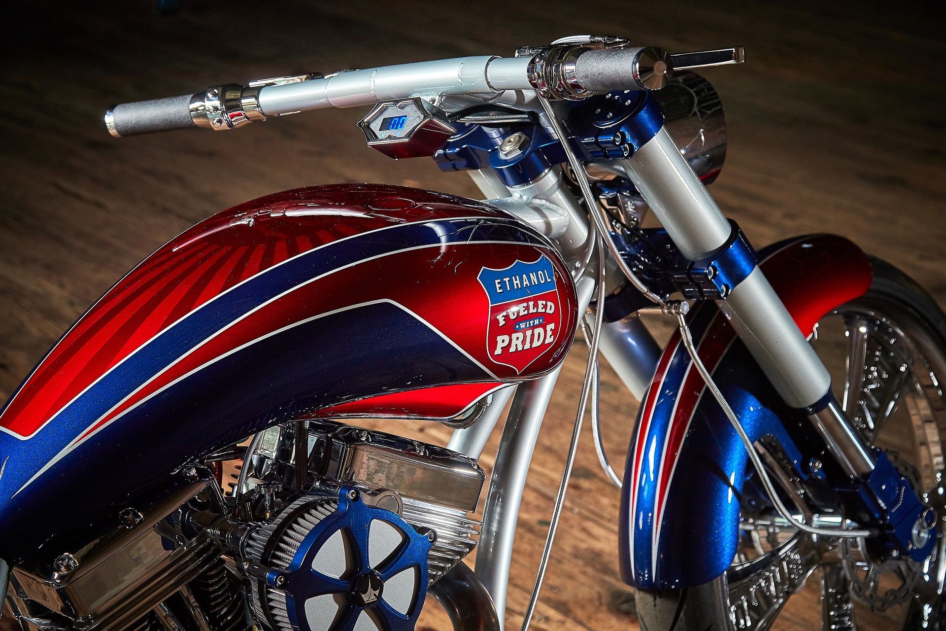 A red white and blue motorcycle with the word pride on the tank