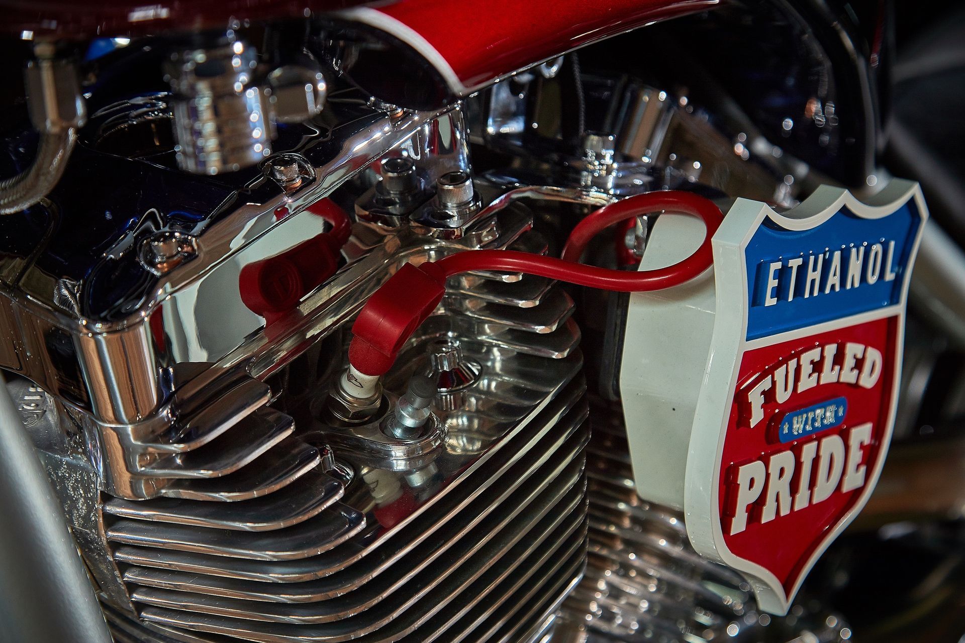 A close up of a motorcycle engine with a sign that says ethanol fueled pride