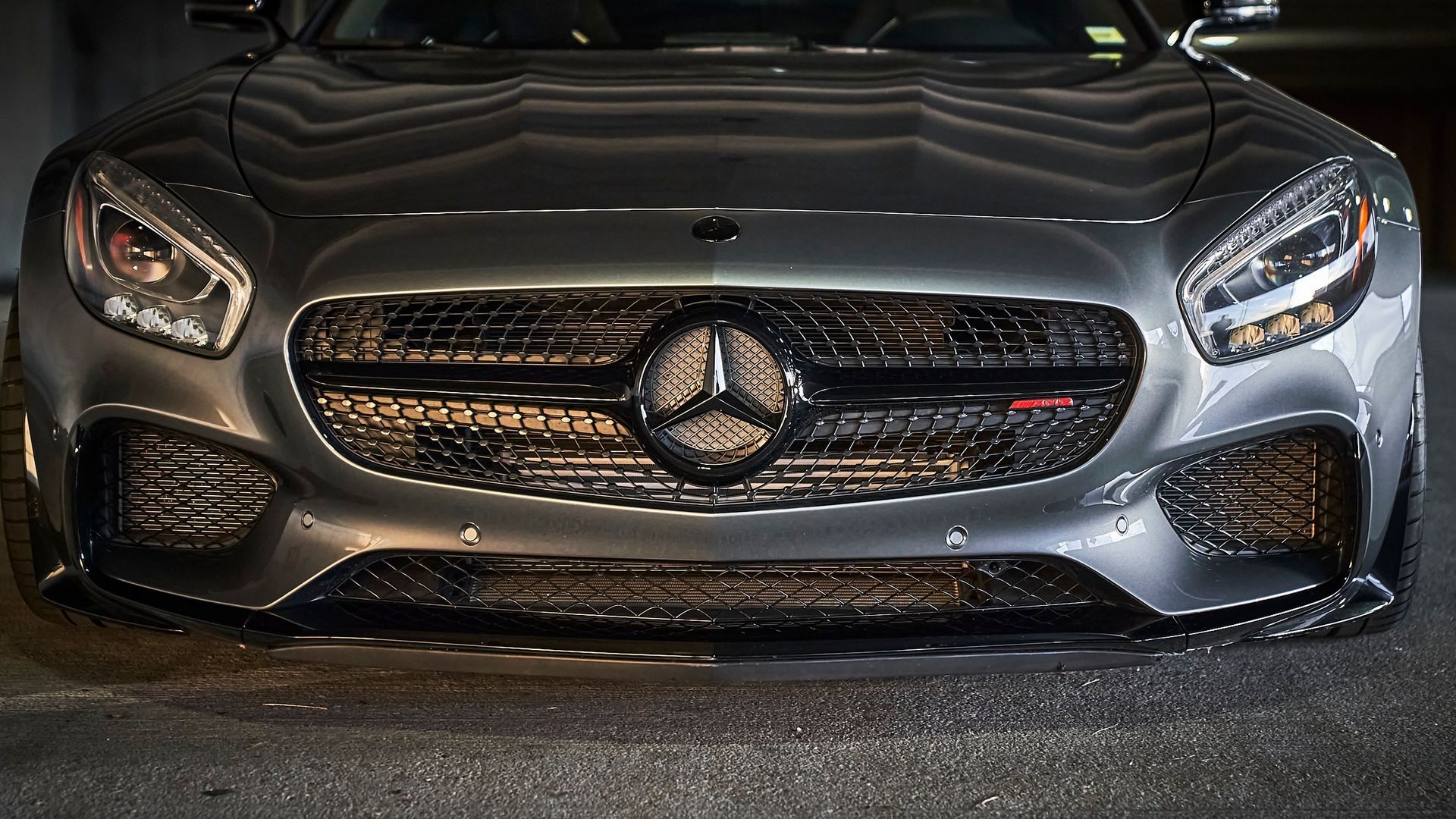 A close up of the front of a mercedes benz car