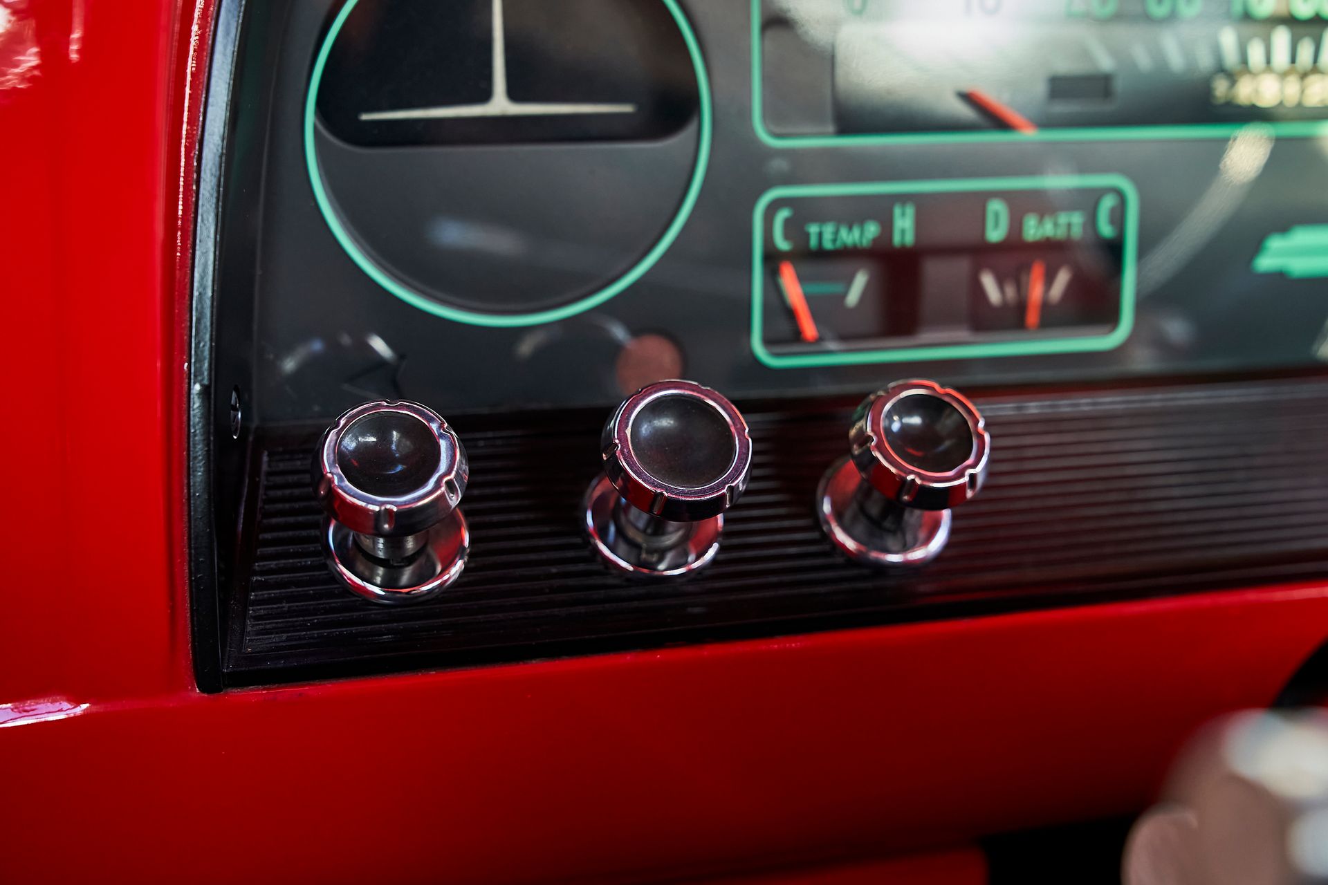 A close up of the dashboard of a red car.