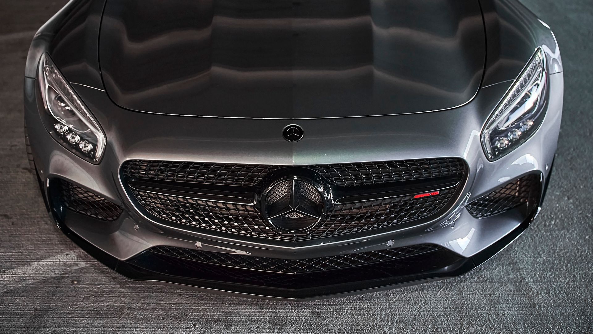 A close up of the front of a mercedes benz car