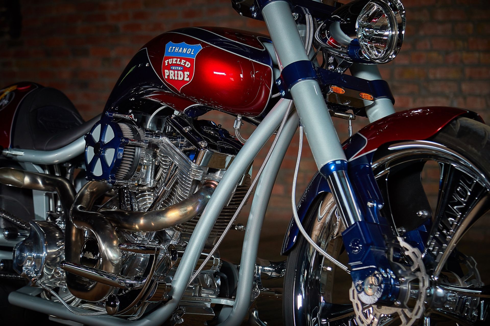 A close up of a red and blue motorcycle with the word here on the tank
