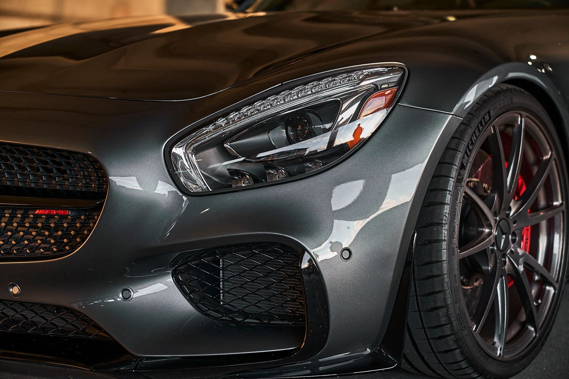 A close up of the front of a mercedes benz amg gt s.