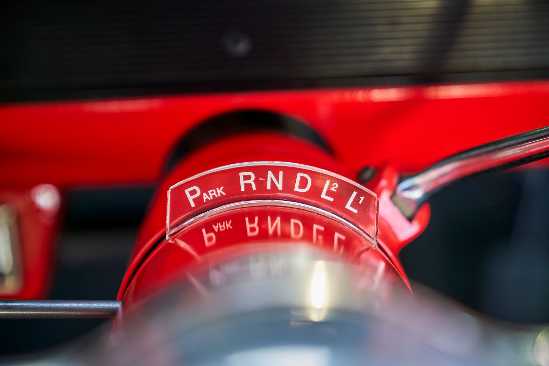 A close up of a red steering wheel with the word rndel on it