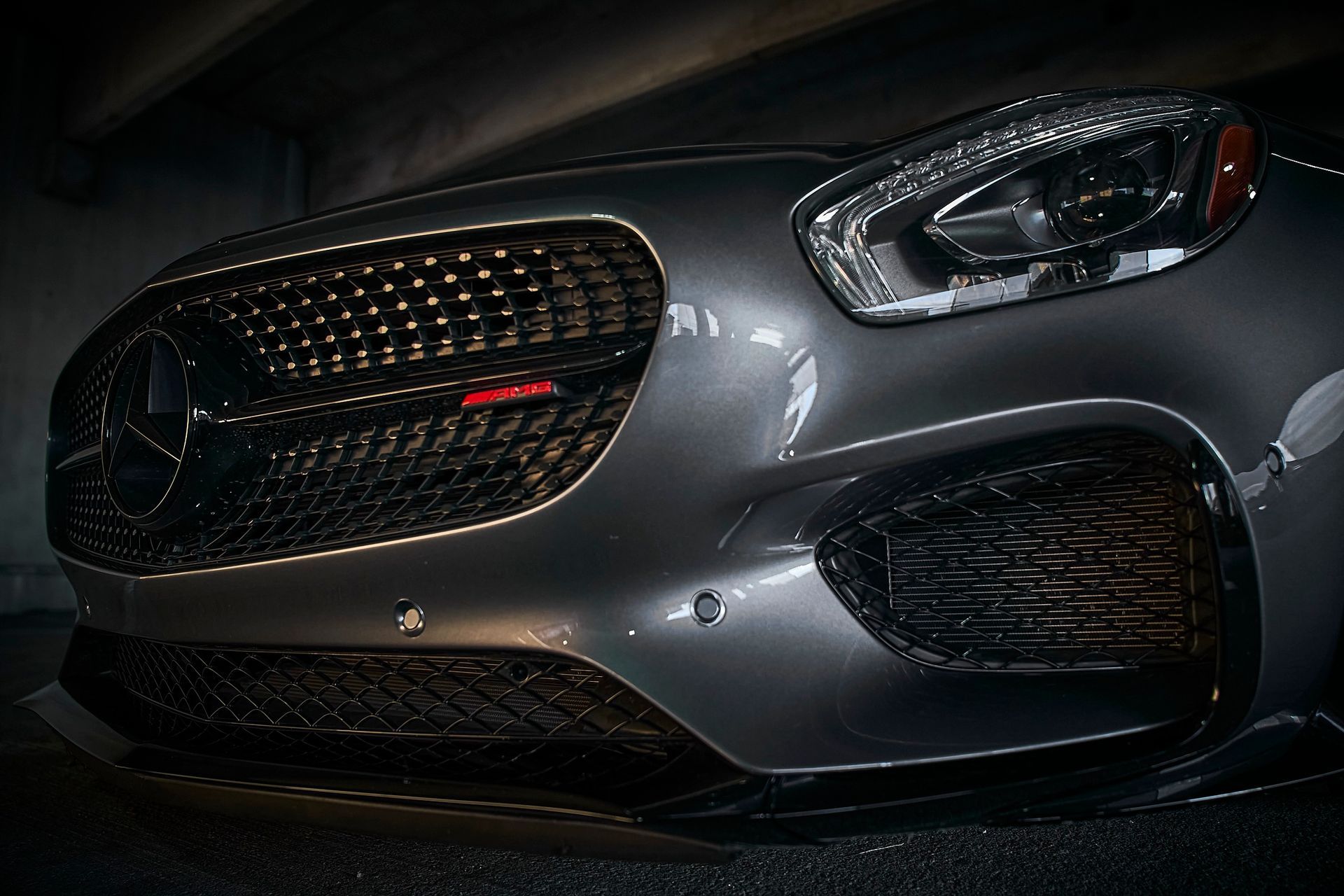 A close up of the front of a mercedes benz car
