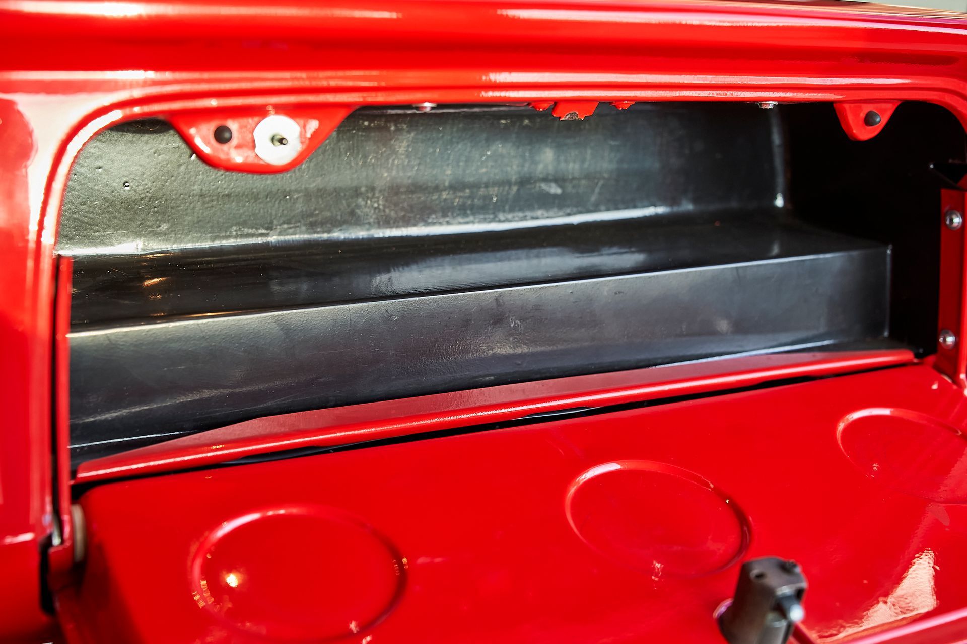 The back of a red car with the trunk open