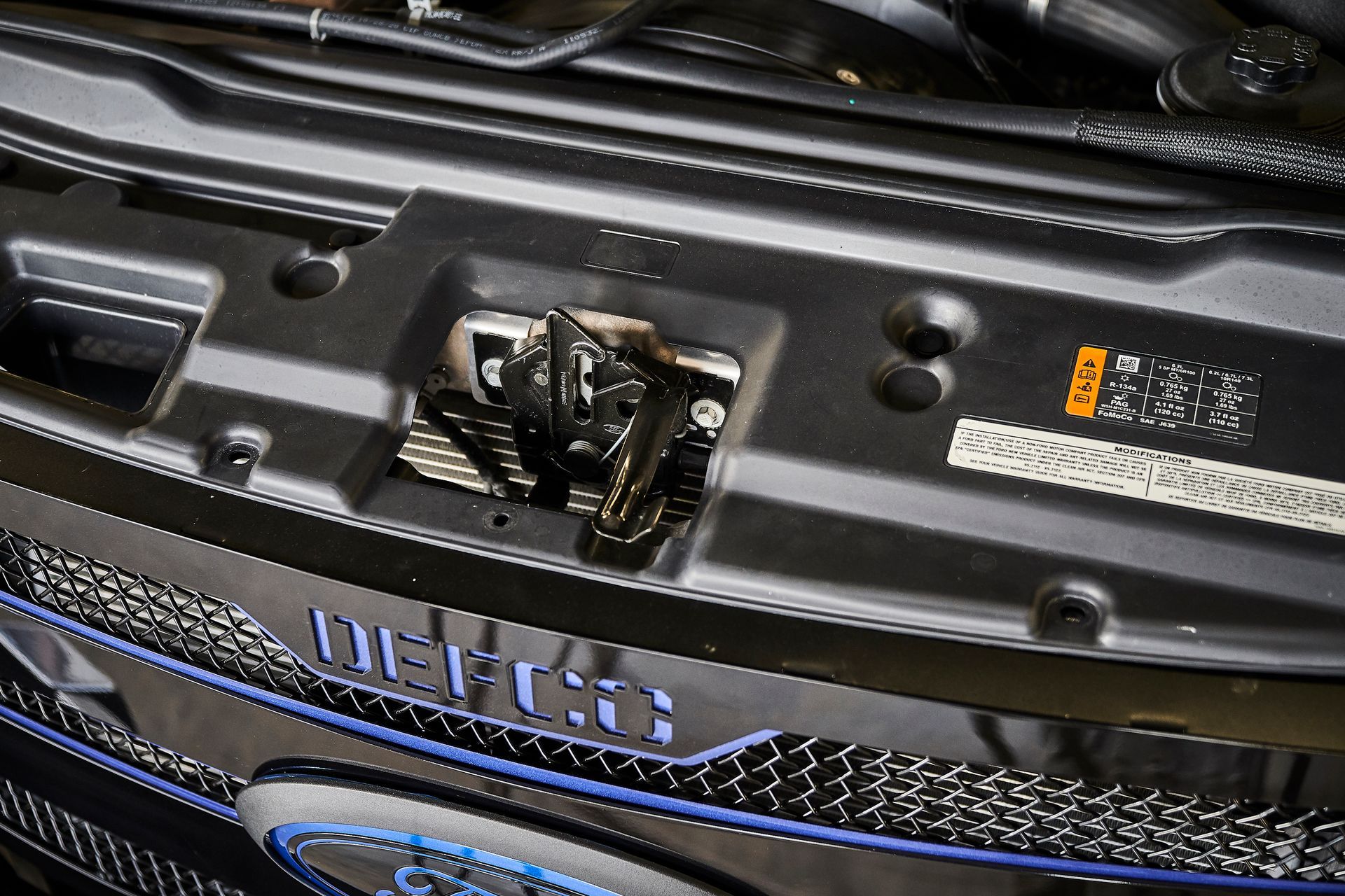 A close up of the hood of a ford car