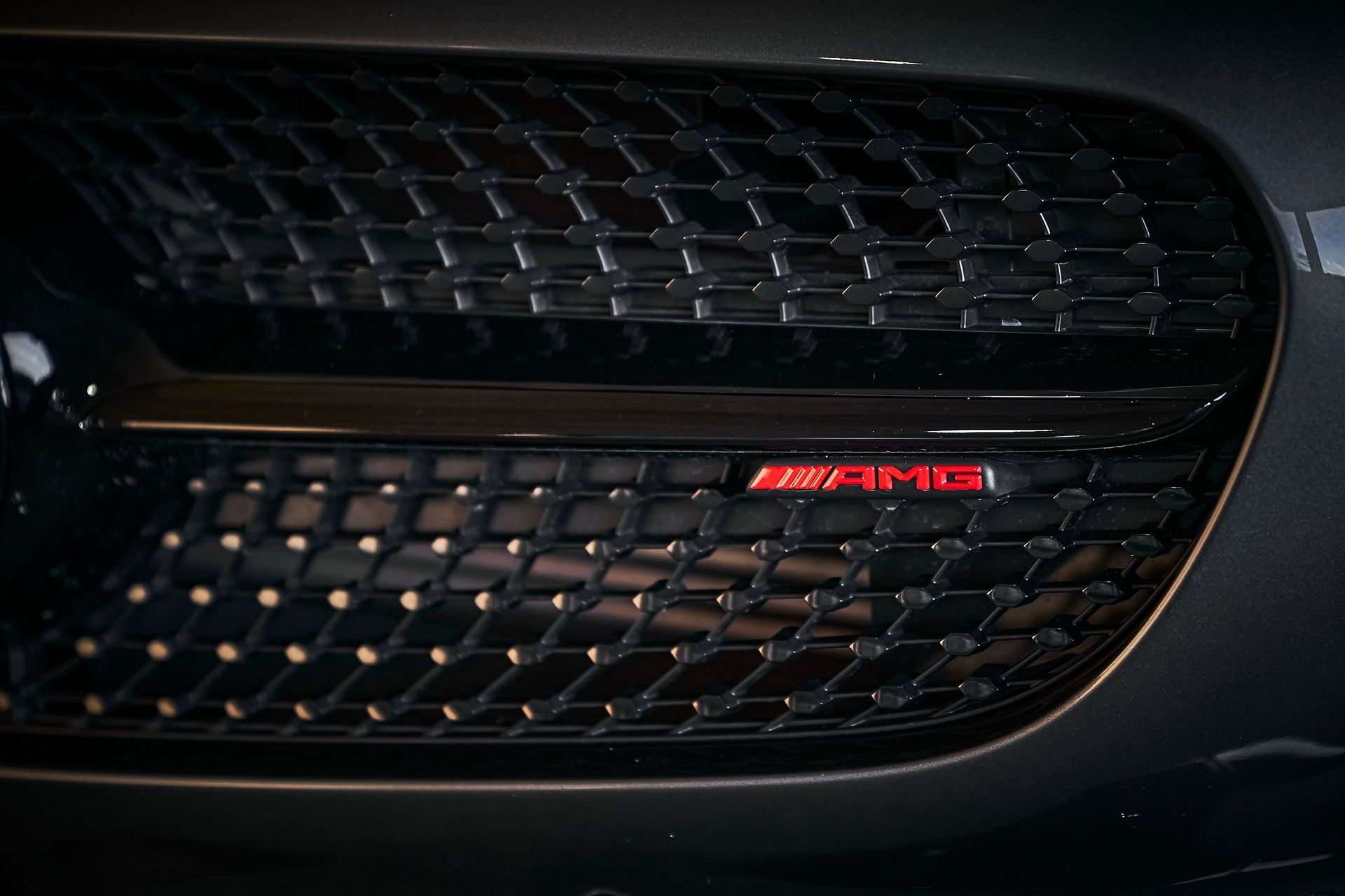 A close up of the front grille of a mercedes amg car.