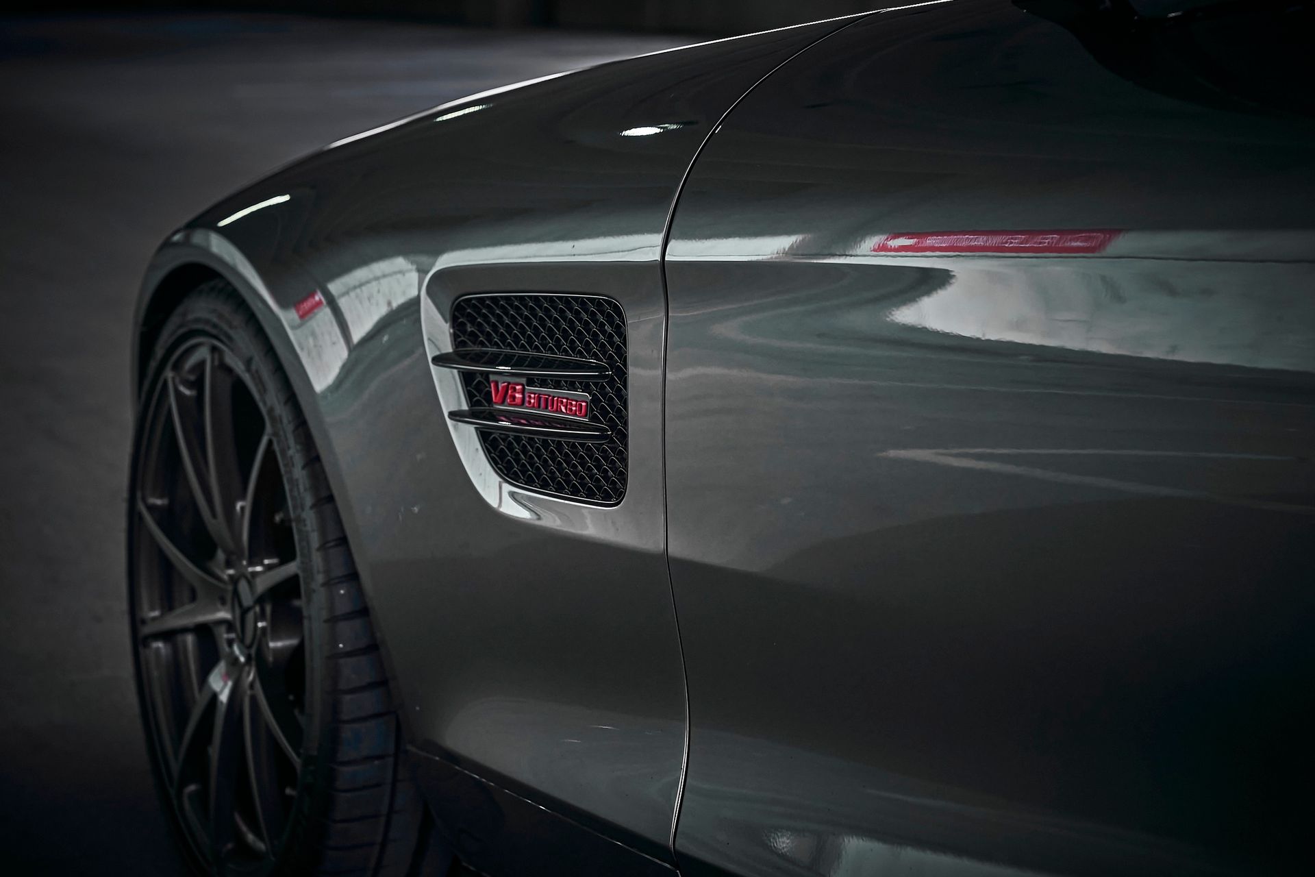 A close up of the side of a mercedes amg gt s.