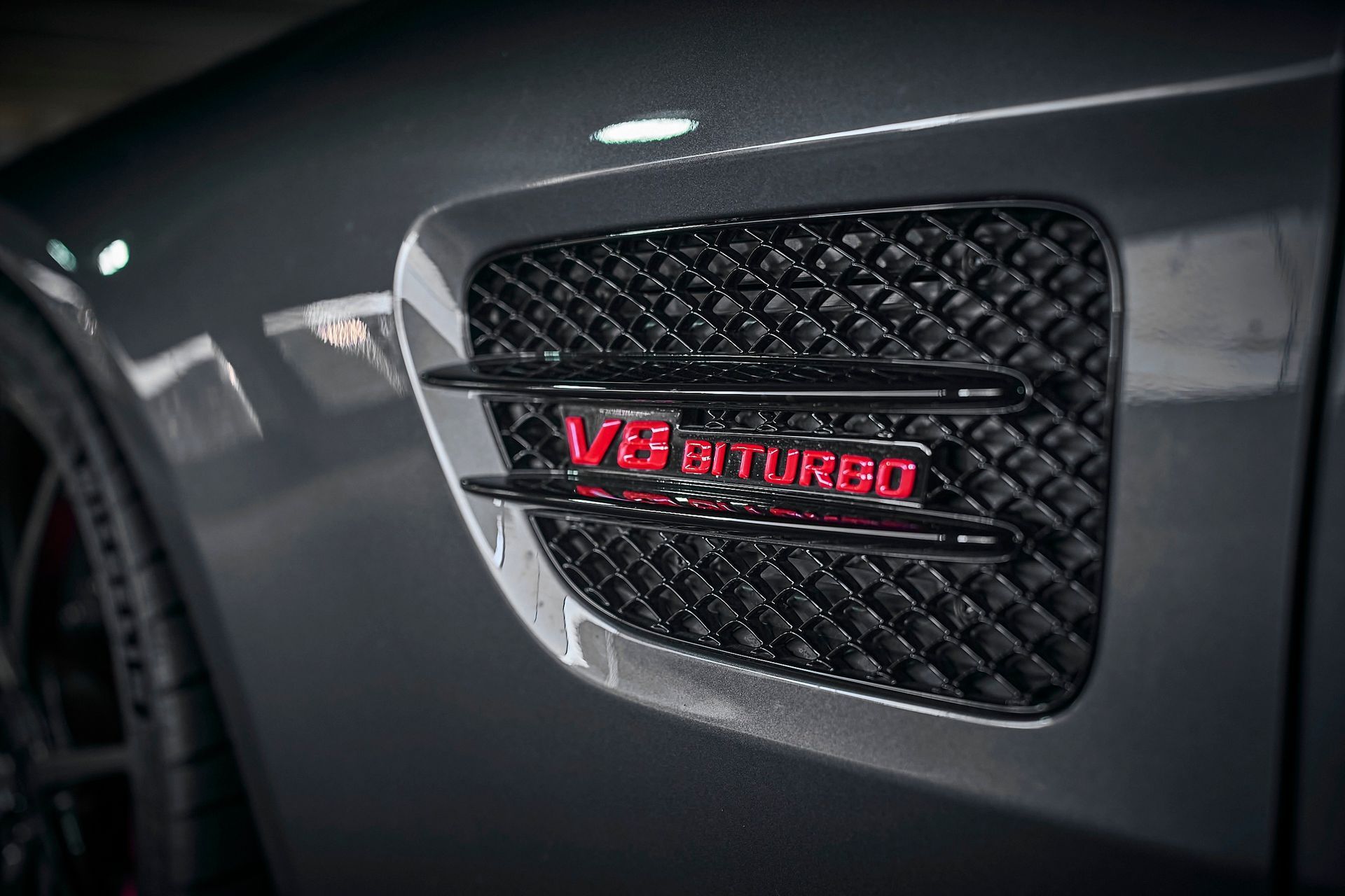 A close up of the side of a car with a v8 turbo emblem on it.