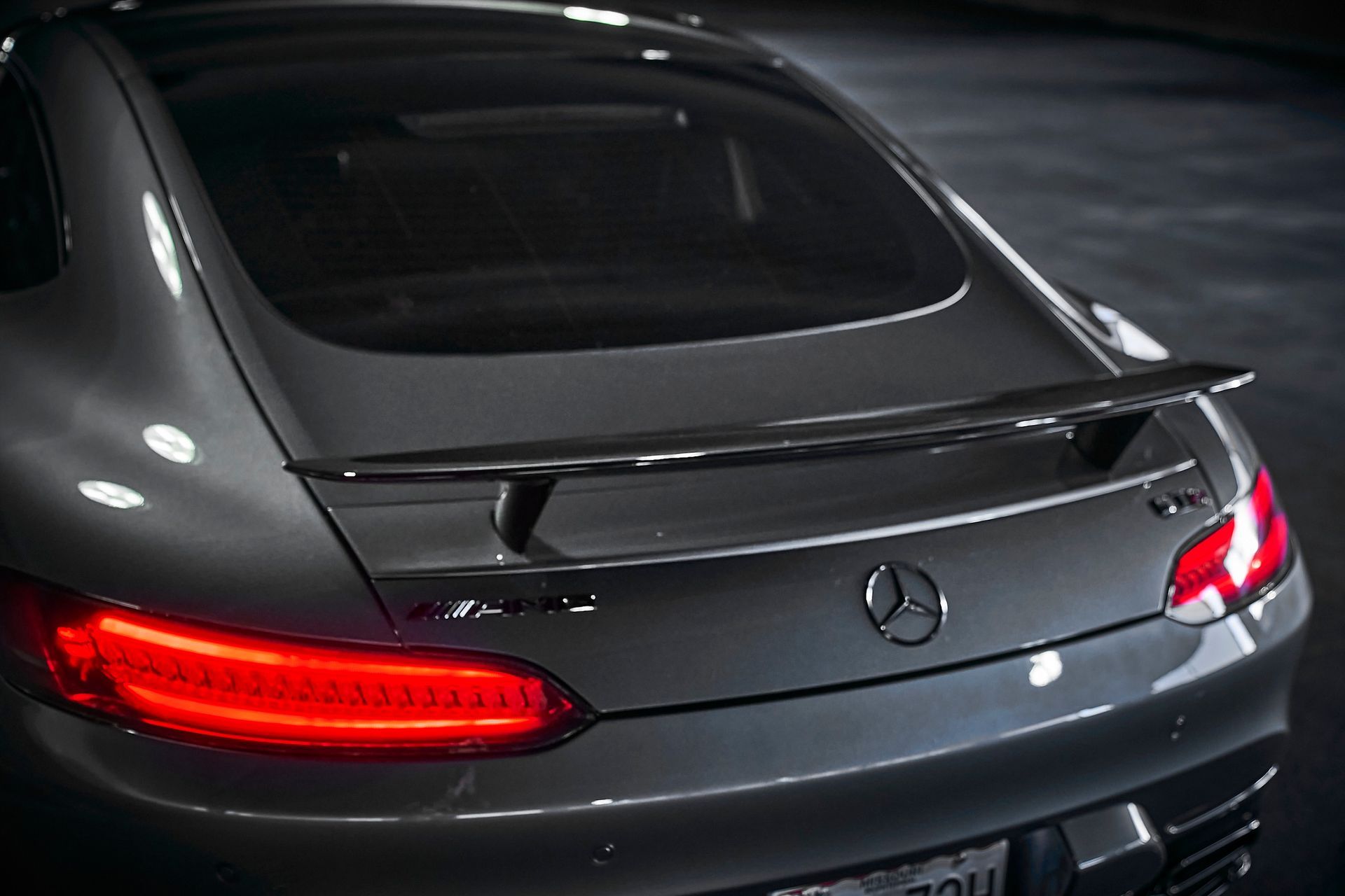 The rear end of a mercedes benz is shown in a close up