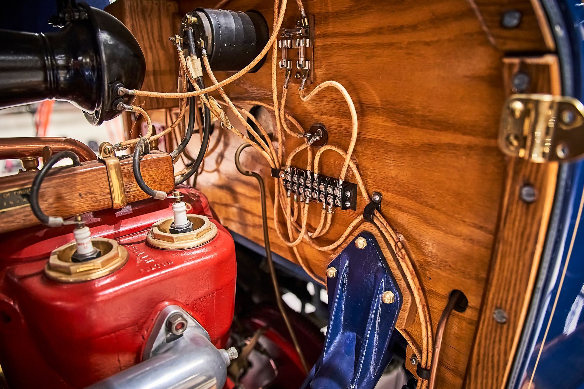 A close up of a red engine in a blue car.
